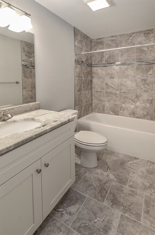 Hallway bathroom view fo single vanity and shower