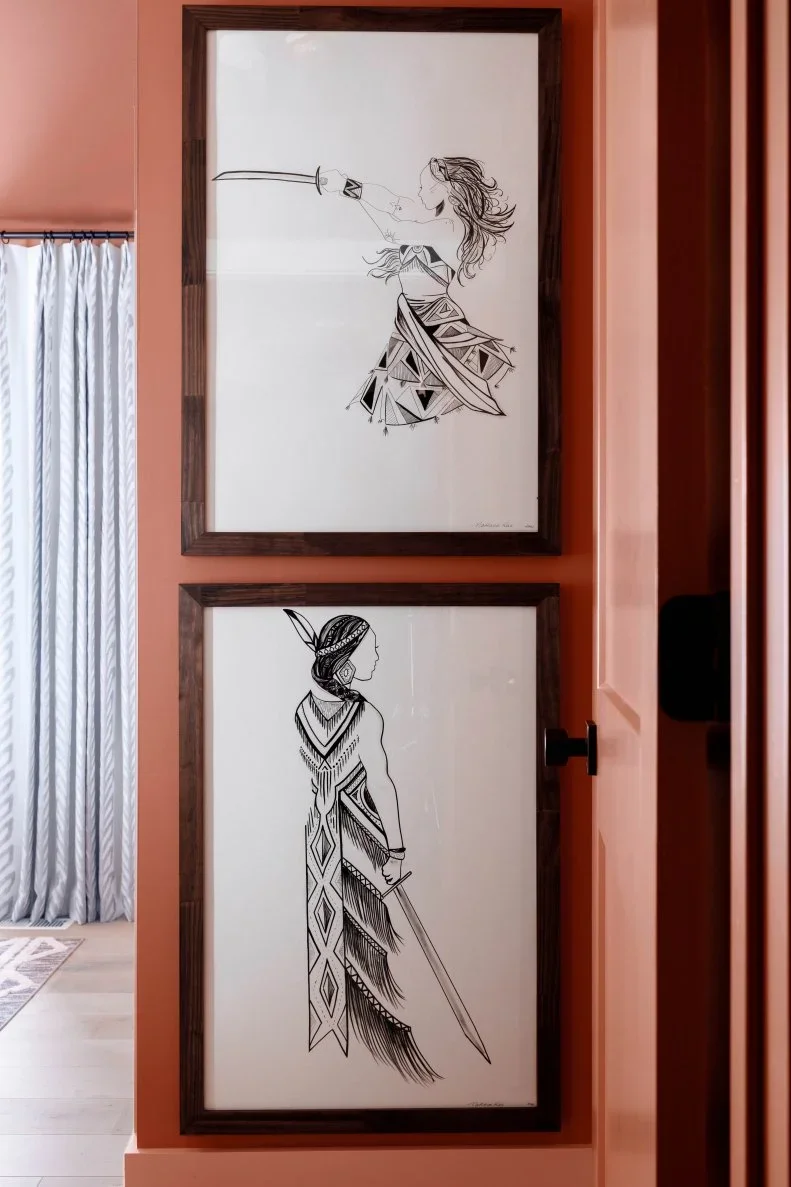 Two Native American ink warrior illustrations by Nathasa Rae framed on display in the entry way to the bedroom in the HGTV Urban Oasis