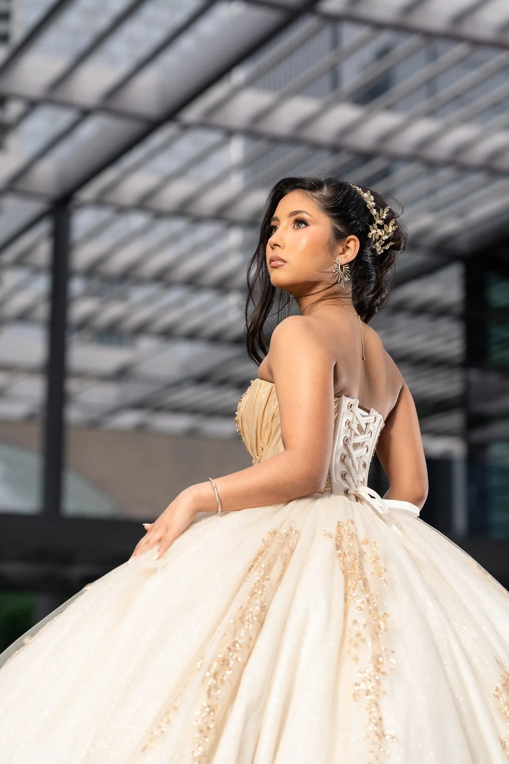 Isabella Aguirre standing gracefully in front of the iconic Winspear Opera House, her gown flowing with elegance as modern architecture meets timeless beauty.