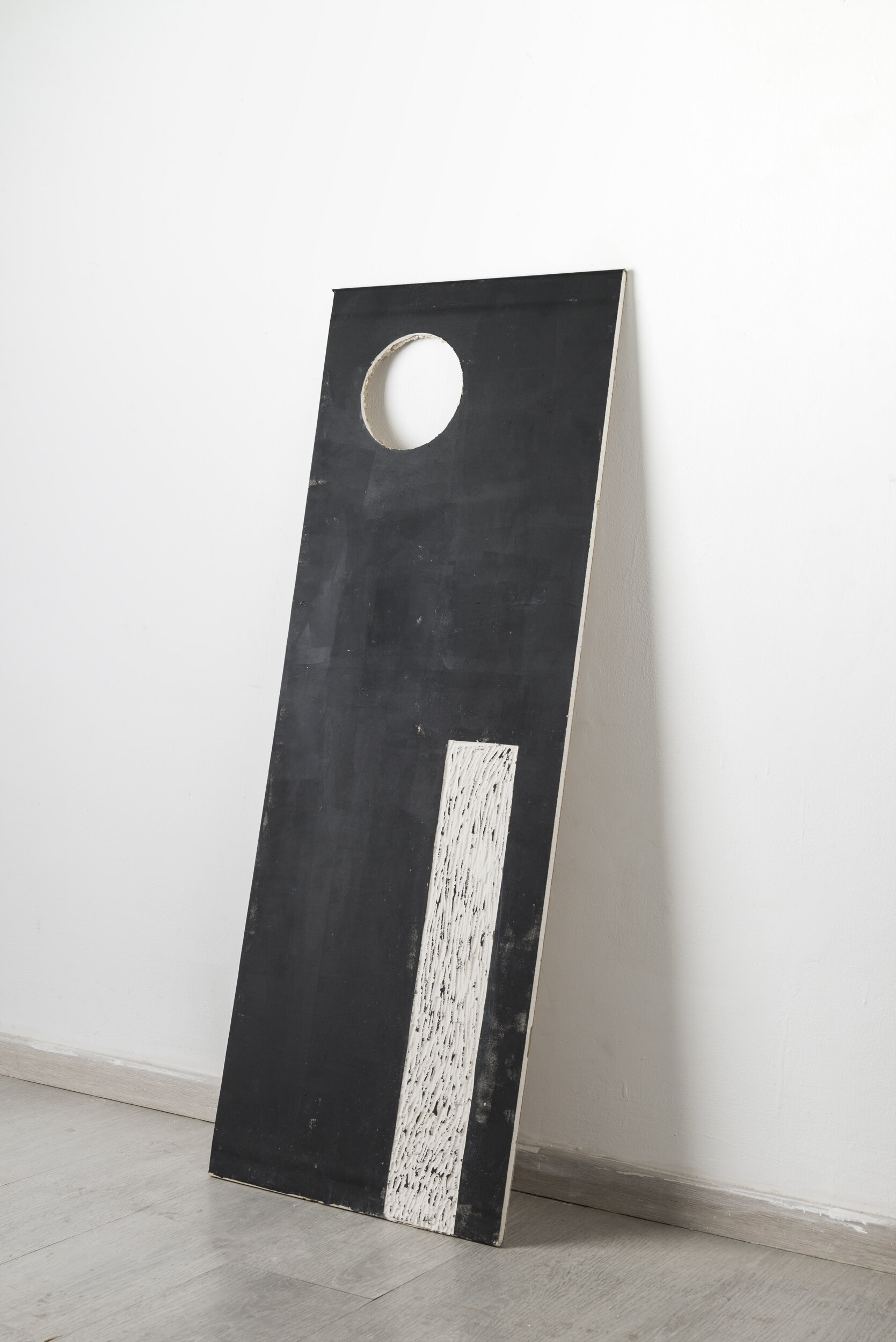 Black hole sun, Plasterboard cut and painted, 44.5x120x1, 2020. Photo credit: Doron Oved