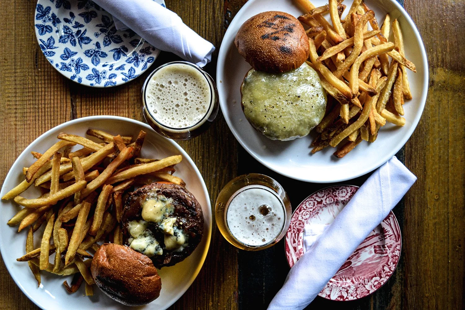 Burgers, Fries, and Craft Beers on a wood table