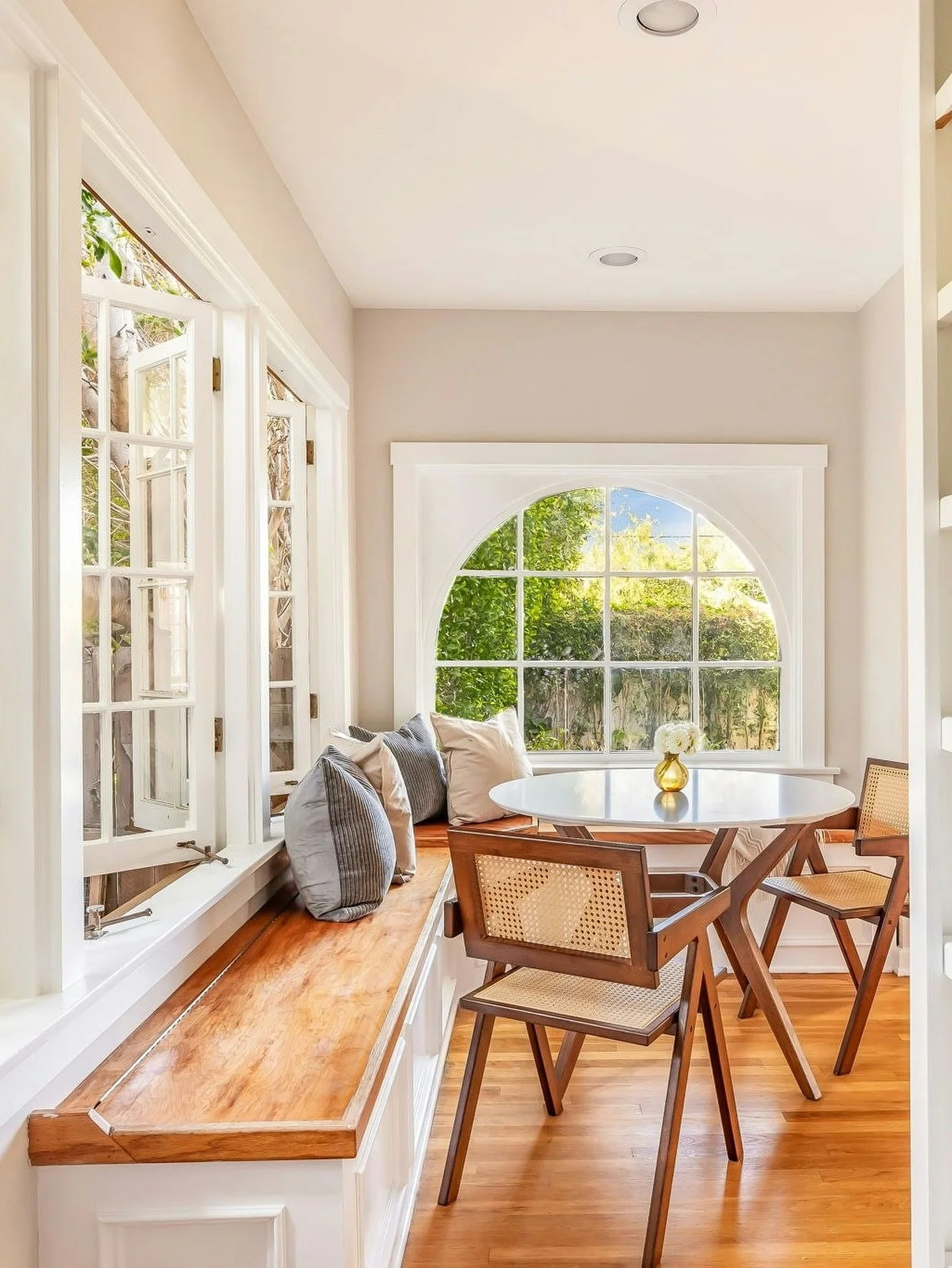 The breakfast nook at Georgina is bathed in natural light and framed by French windows, making every meal feel easy and inviting.