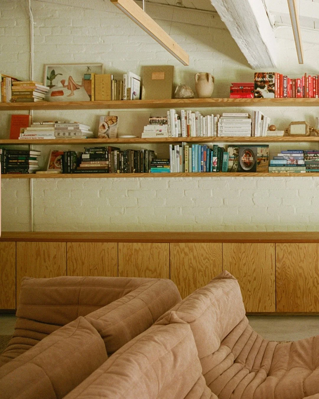 A soft, sunlit nook where work and rest coexist. Built-ins in pale wood and muted tones bring a quiet order to this Lower Mandeville home.

Photo by @nickisebastian