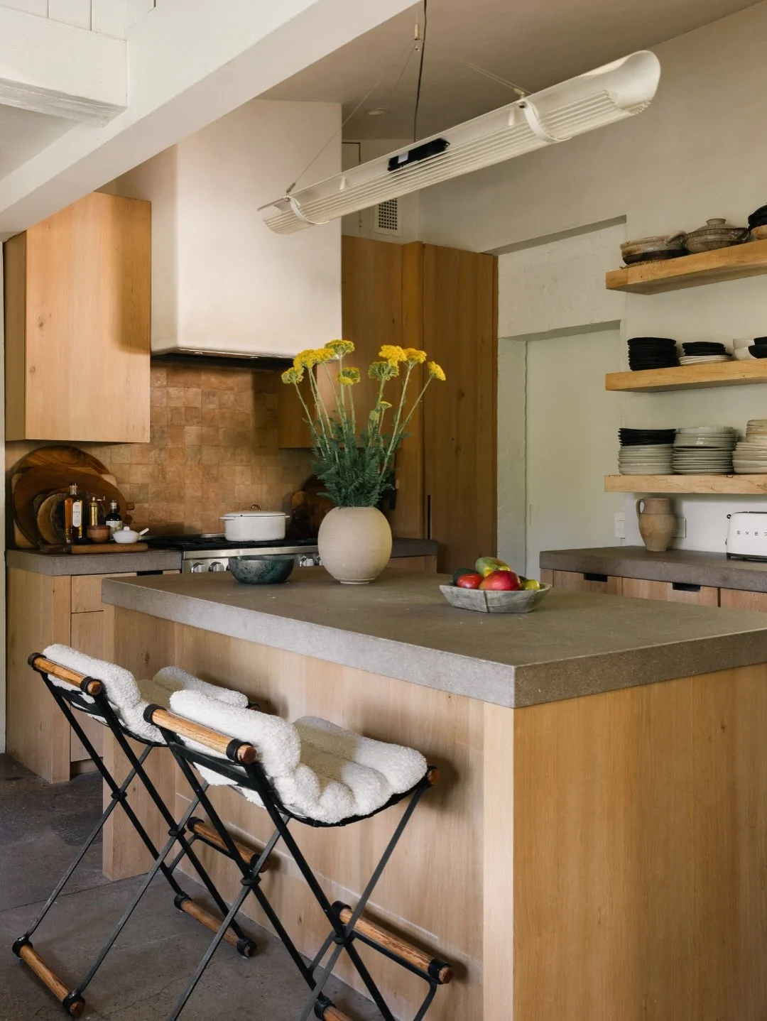 The kitchen at Old Orchard feels like a natural extension of the home itself.

Thoughtfully renovated with Miele appliances, custom shelving crafted from repurposed silver maple, and bespoke lighting throughout, the space balances warmth and function