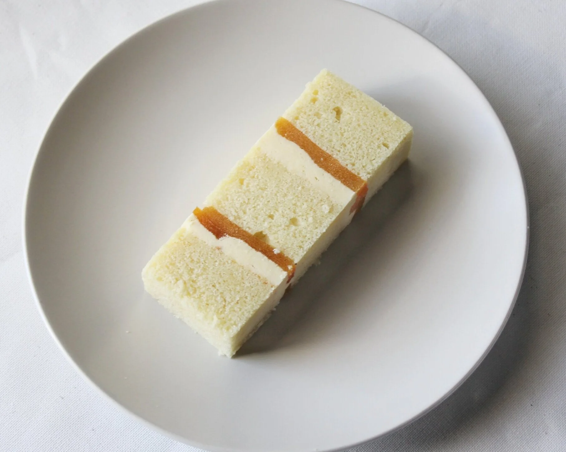 PASSIONFRUIT WHITE CHOCOLATE MOUSSEVanilla cake, passionfruit simple syrup, passionfruit gelee, white chocolate mousse, toasted coconut flakes.