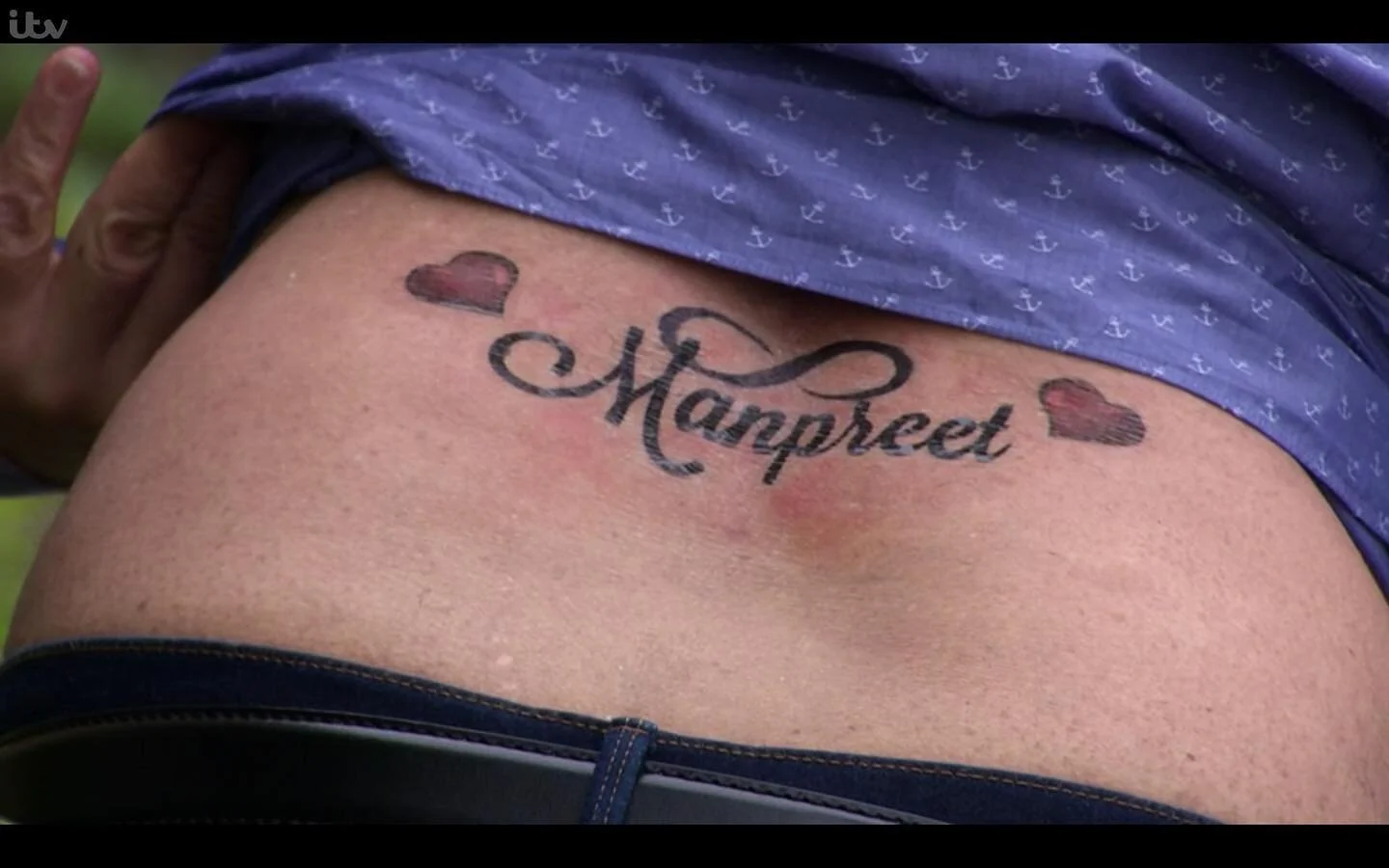 #emmerdale 
[ID a close up of Rishi’s lower back. He’s lifted his blue shirt to reveal a tramp stamp that says ‘Manpreet’ in brush script with a red love heart on either side. It’s supposed to still be healing, thus why