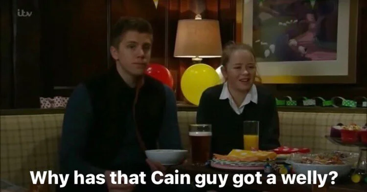 Why has that Cain guy got a welly?
#emmerdale 
[ID Robert and Liv are sat next to each other in The Woolpack. There’s some balloons and paper chains to imply there’s some sort of Dingle knees up. Liv’s school uniform also implies