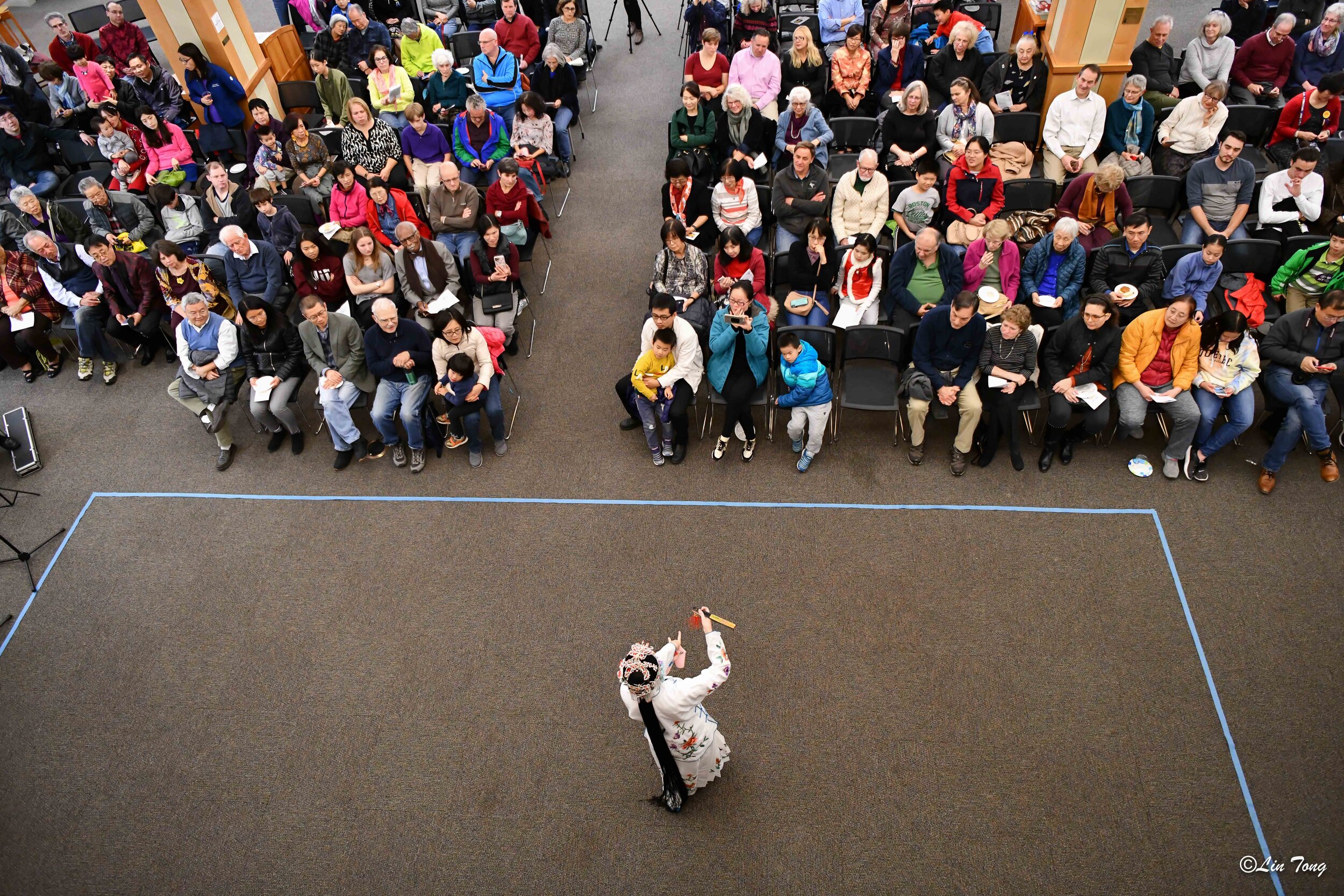  Overhead shot of Chinese woman folk dancing in front of a crowd 
