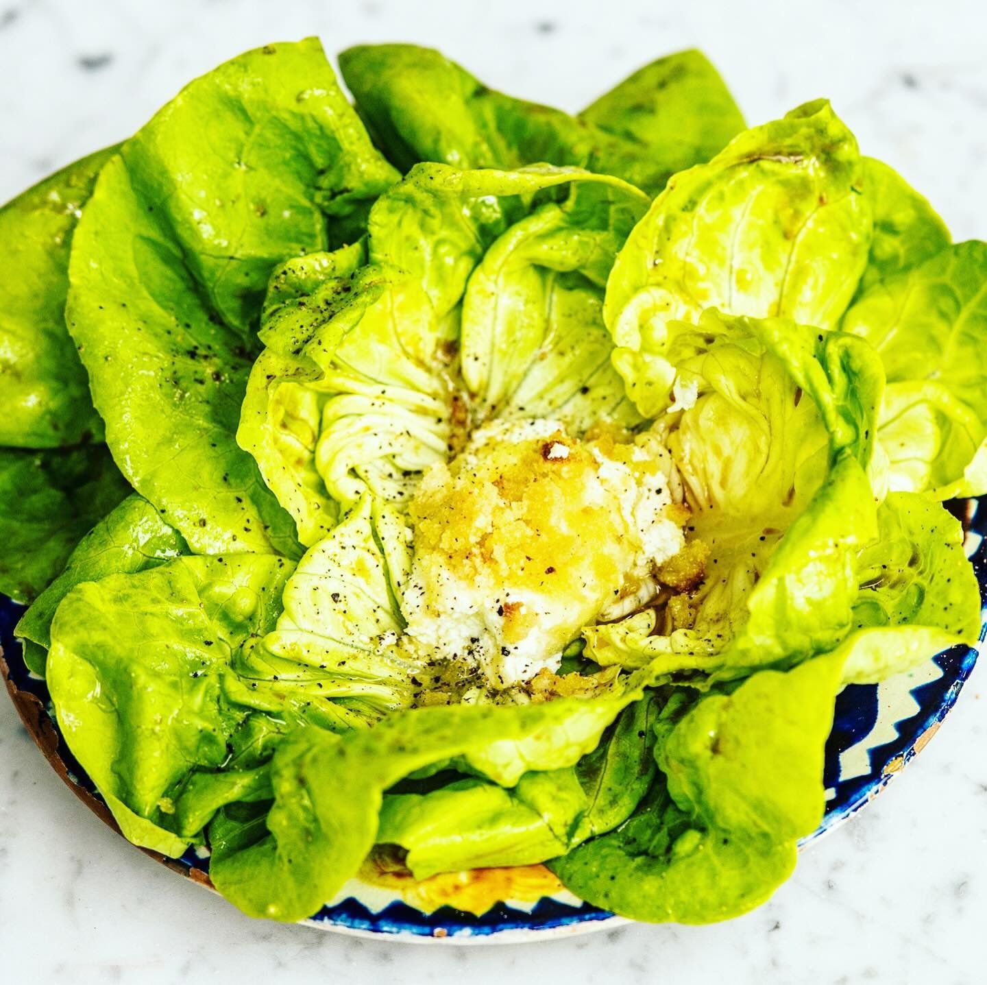 Easy Bibb Salad&mdash;For each guest, open a small head of Bibb lettuce into a flower shape, plate, drizzle with a dressing of choice, and top with Baked Goat Cheese and cracked pepper. Find the link to the recipe in my bio.
+
I am Sally Uhlmann. My 