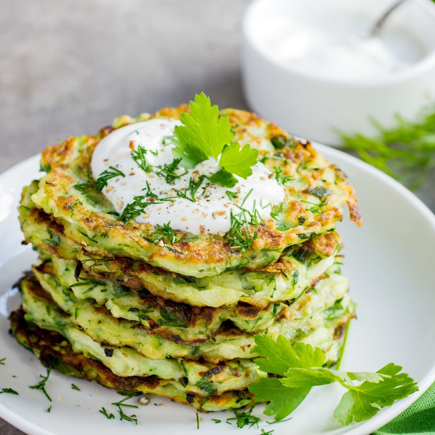 These savory, flavorful Zucchini Fritters are delicious whether enjoyed hot from the skillet or at room temperature. They bridge the gap between comfort food and gourmet appetizer, making them ideal for any occasion. The yogurt sauce can be made up t