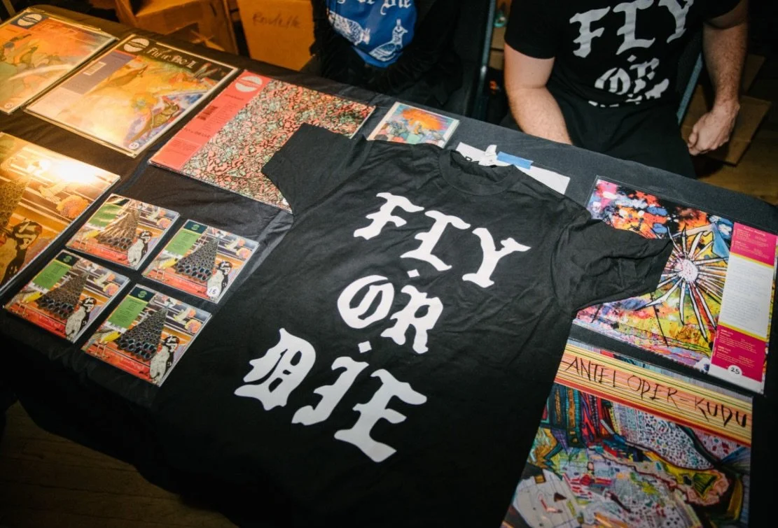 **BY POPULAR DEMAND**
Now shipping from the beautiful city of Chicago, IL:

Limited-edition &ldquo;𝕱𝖑𝖞 𝖔𝖗 𝕯𝖎𝖊&rdquo; t-shirt by Roberto Carlos Lange (( aka @heladonegro )). Printed on Black Gilden Heavy Cotton T-Shirts.

All proceeds go to Th