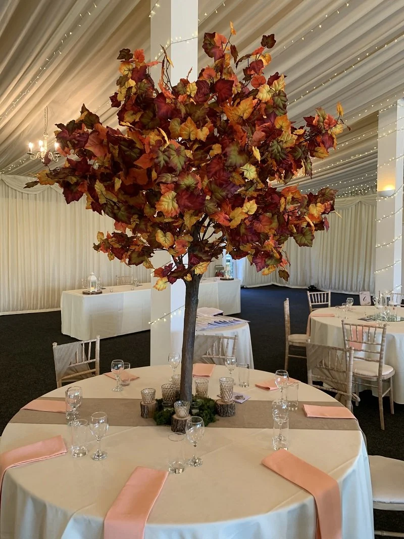 1.8m wedding table trees used as statement centrepieces in blossom, greenery and autumn styles