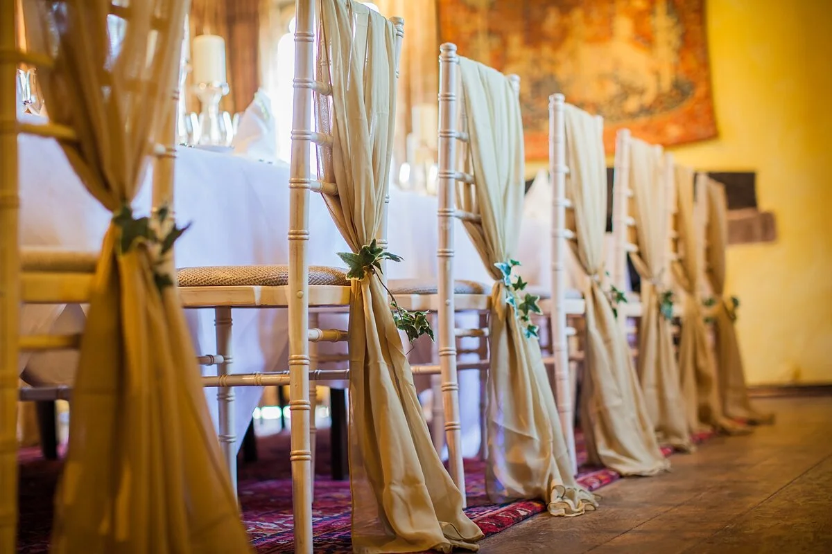 Vertical Drops wedding decorations styled with ceiling draping and fairy lights in an elegant marquee reception.