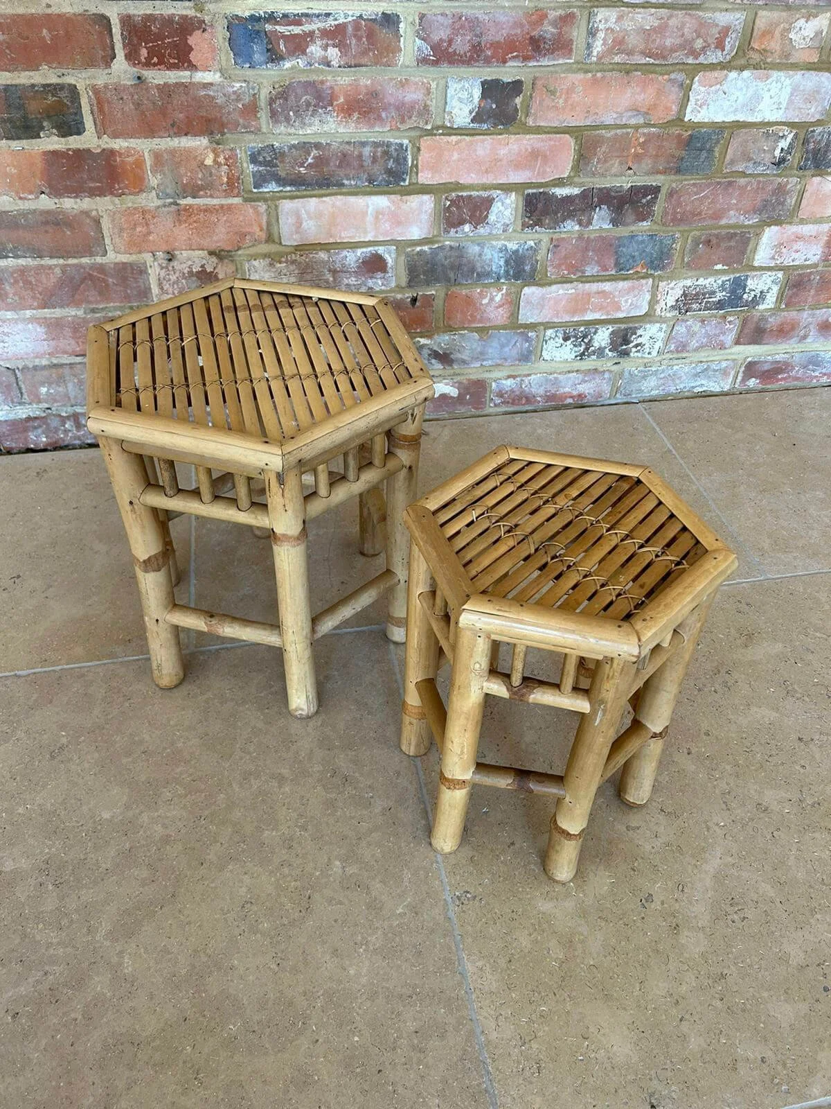 Bamboo Hexagonal SideTables x 2 — Default — C.2 shown as two different height hexagonal bamboo side tables on tiled floor with brick wall background.