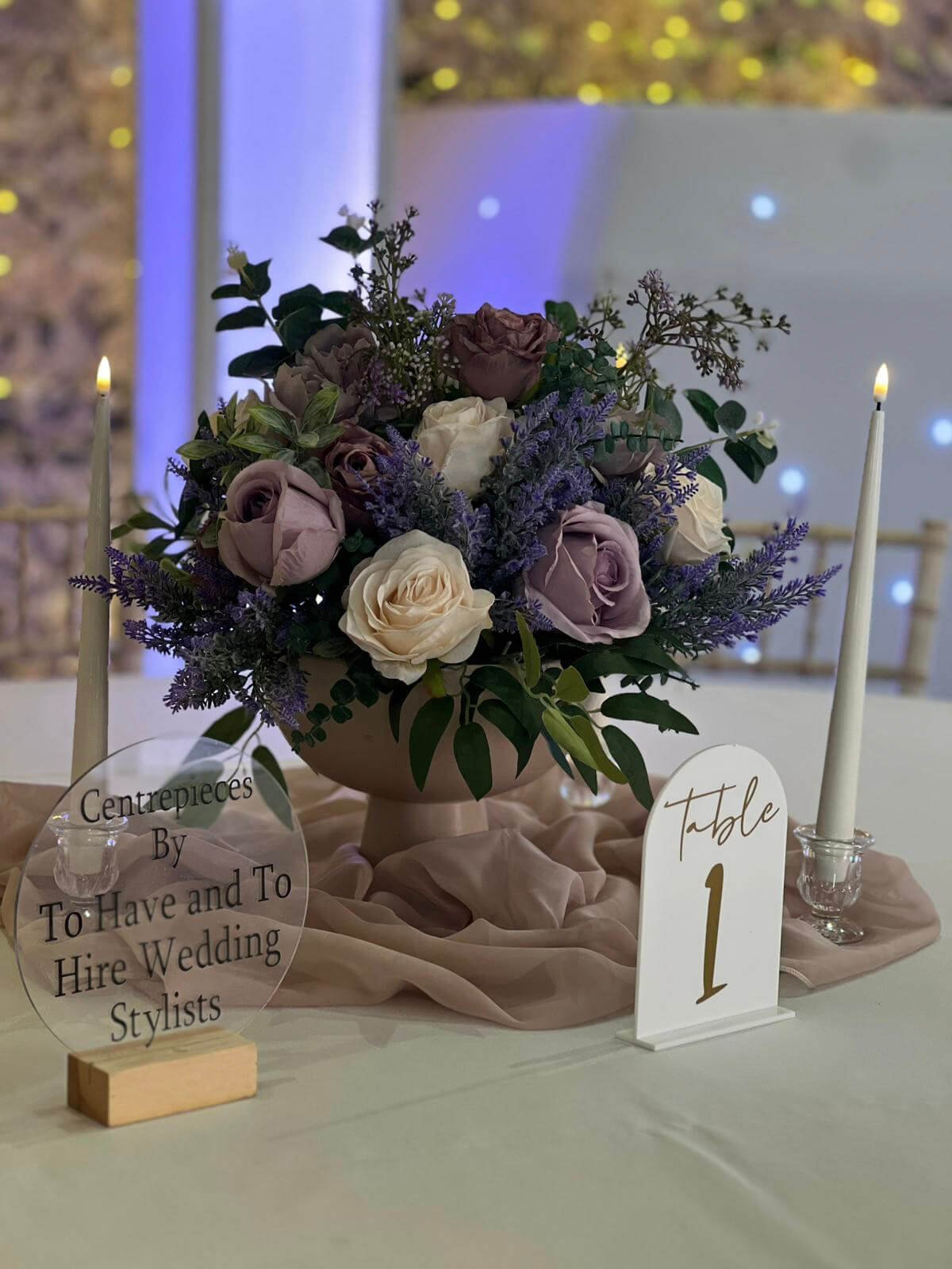Ceramic Pedestal Footed Bowl filled with purple and cream faux roses and greenery, available to hire for your wedding or event.