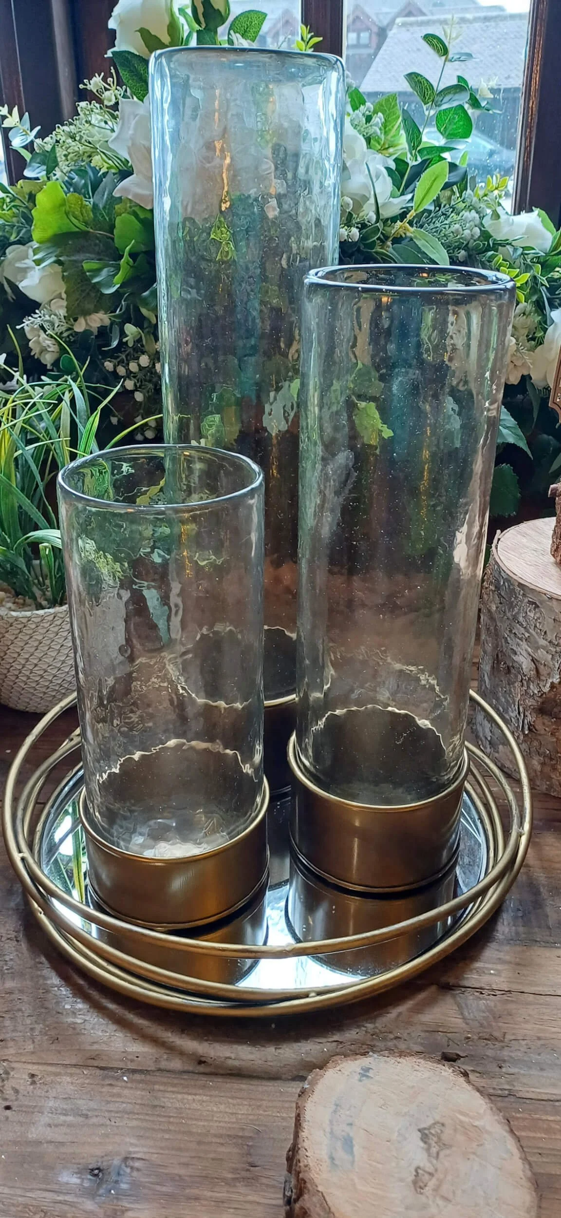 Gold Base Cylinder Vase - 25cm with clear glass and gold base on a gold tray, available to hire for your wedding or event.