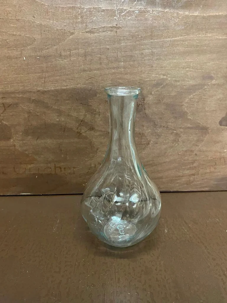 Mini clear bulb vases with a bulbous base and narrow neck, available to hire for your wedding or event.
