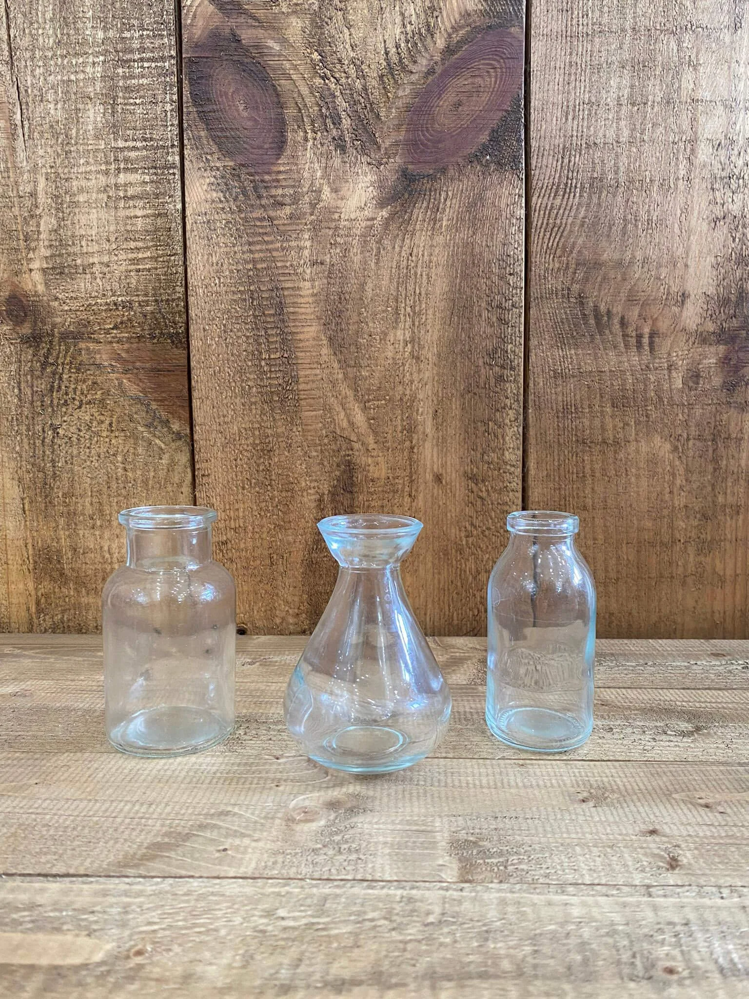 Mini Glass Vases - Assorted - 10cm height, three clear glass vases in different shapes, available to hire for your wedding or event.