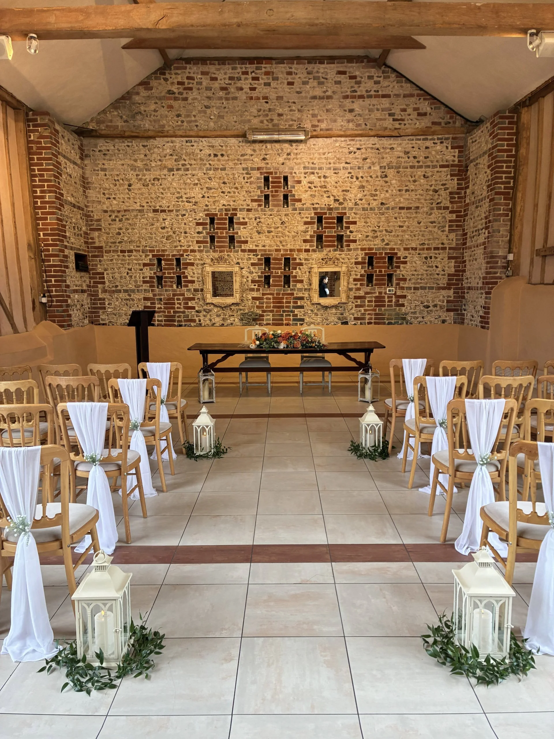 Cream Antique Lantern - Medium placed along the aisle in a wedding ceremony setup, available to hire for your wedding or event.