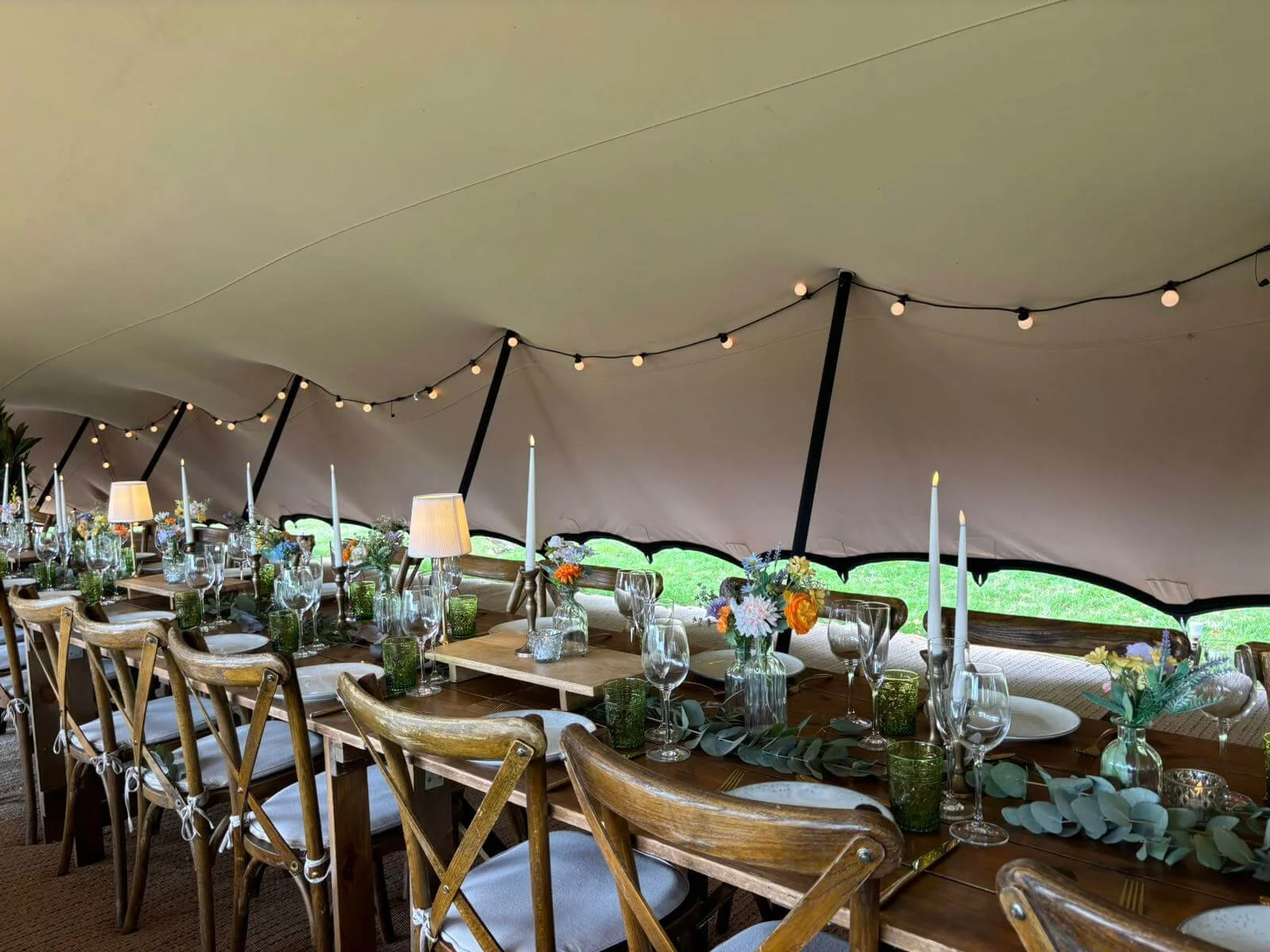Rustic Sharing Risers displayed on a long wooden table with candles and flowers, available to hire for your wedding or event.