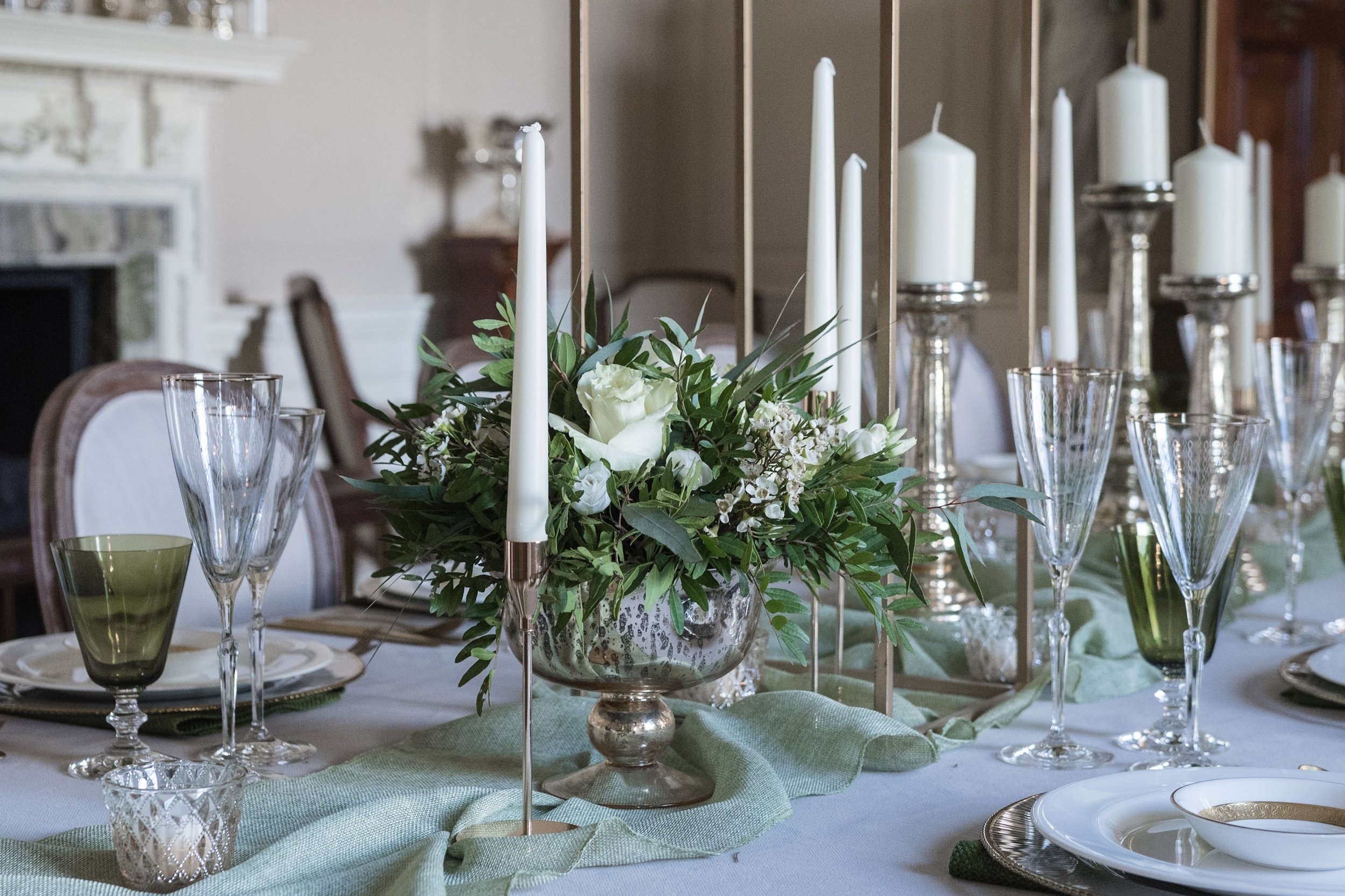 Pedestal Footed Bowl - Gold filled with white flowers and greenery, available to hire for your wedding or event, displayed on an elegant dining table.