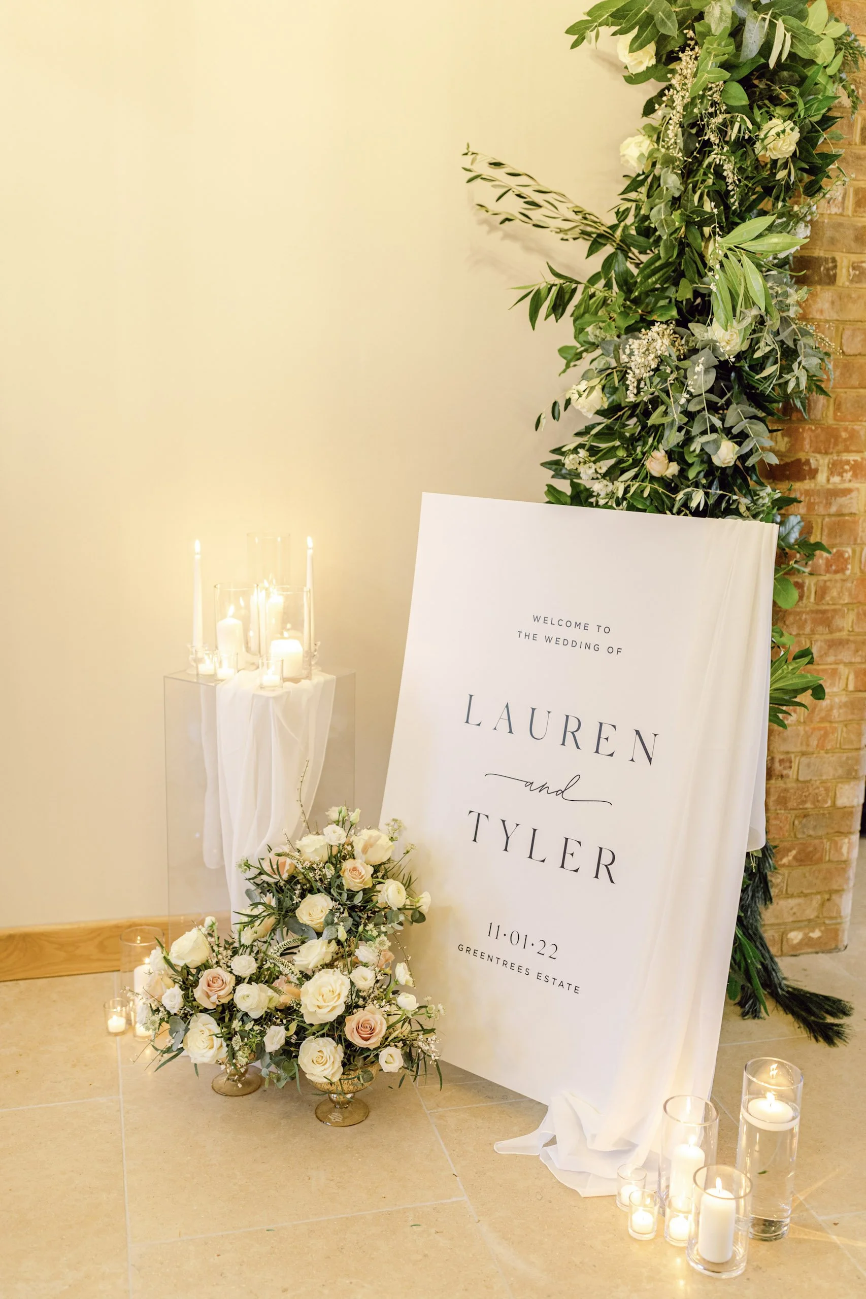 Cylinder Vase - 50cm - WIDE 20cm with white candles inside on a clear stand draped with white fabric, available to hire for your wedding or event.