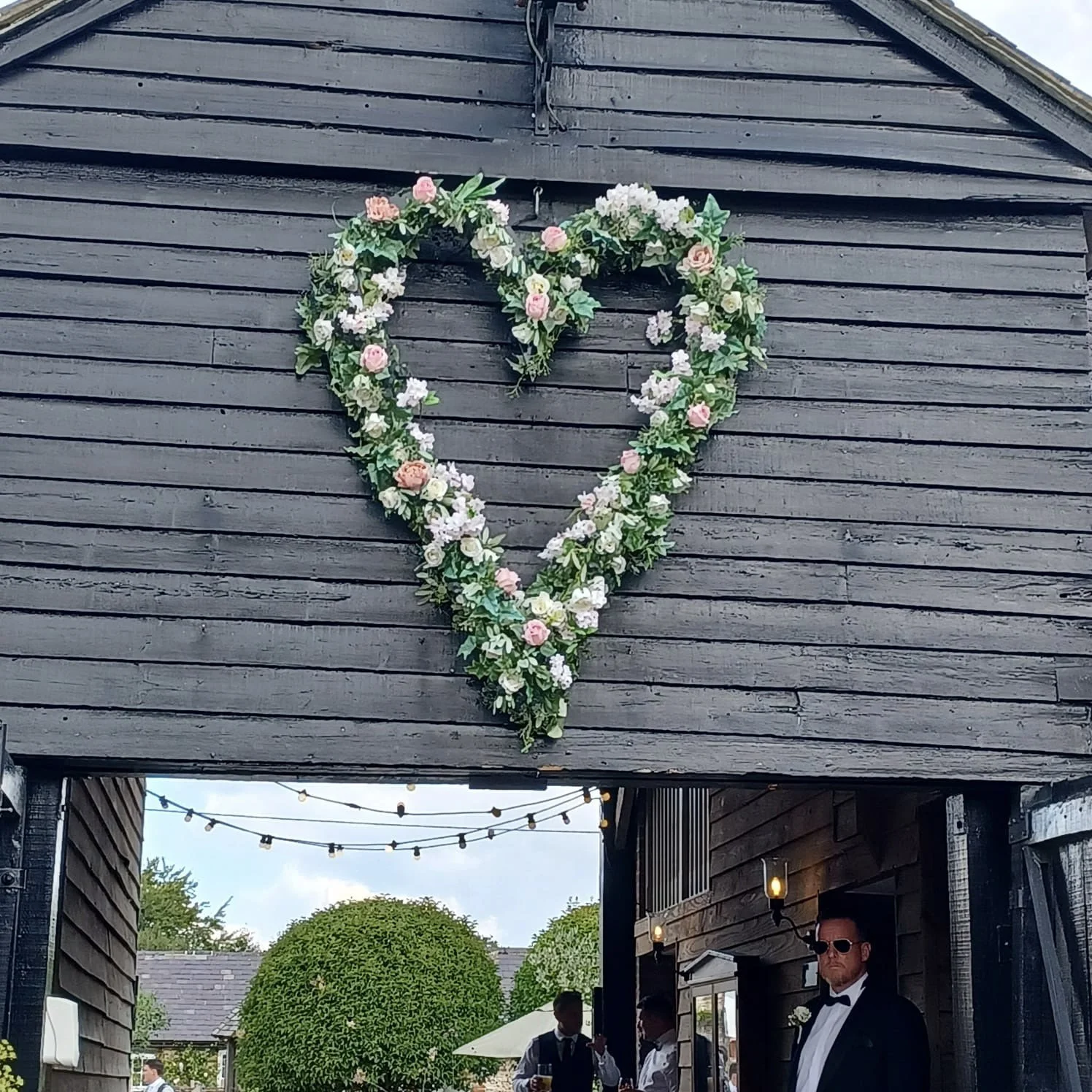 Giant Heart floral wreath with pink and white flowers and green leaves, available to hire for your wedding or event.