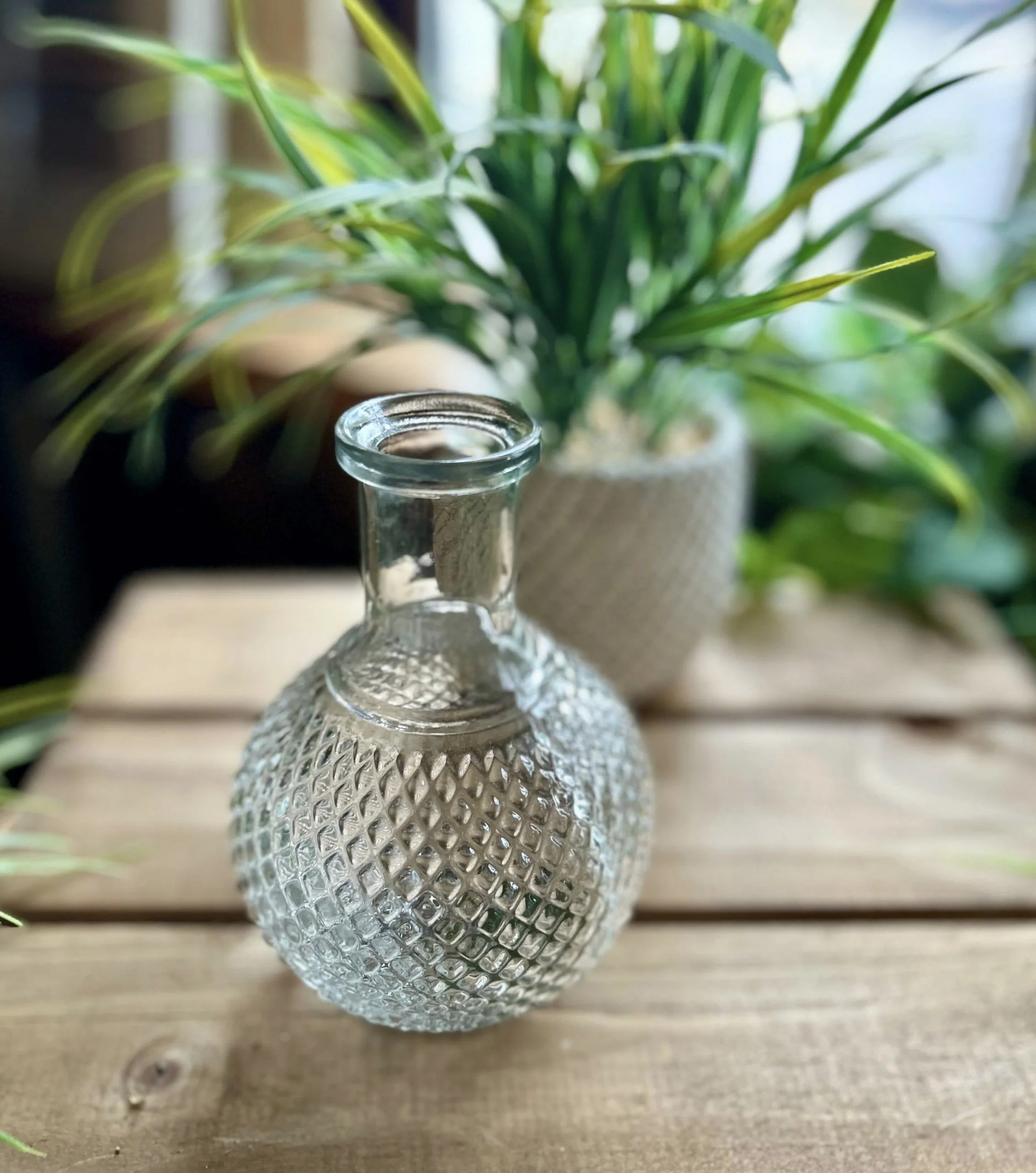 Vintage Bud Vase - 15 cm clear textured glass vase with narrow neck and rounded body, available to hire for your wedding or event.
