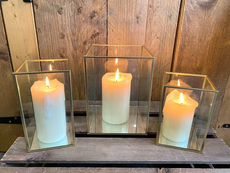 Black Square Lantern - Small with lit white pillar candle inside, available to hire for your wedding or event.
