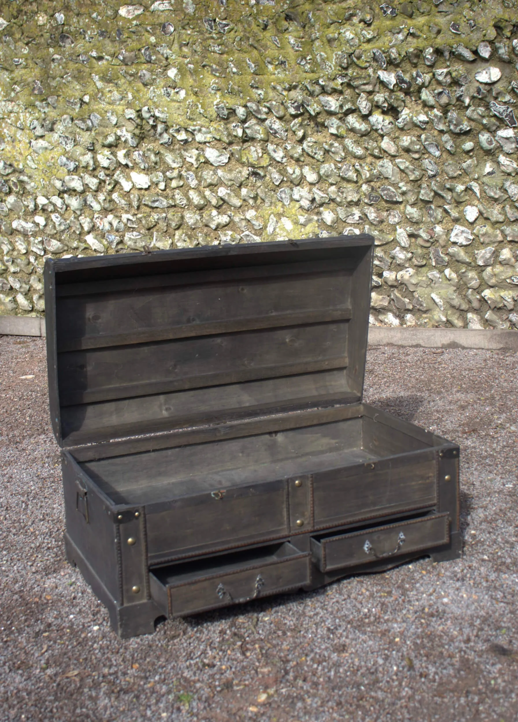 Black Chest with drawers with open lid showing interior, available to hire for your wedding or event.