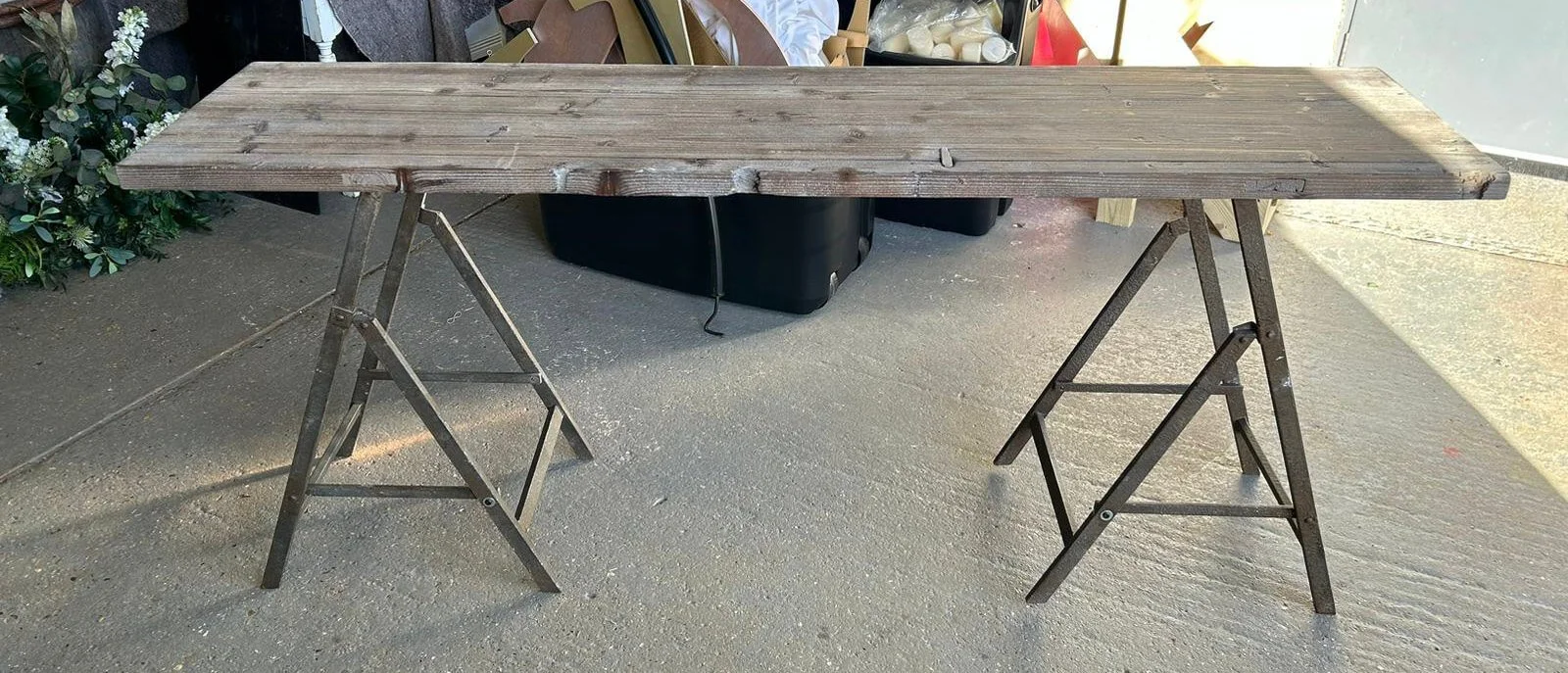 Potting Table - Long with a rustic wooden top and metal trestle legs, available to hire for your wedding or event.