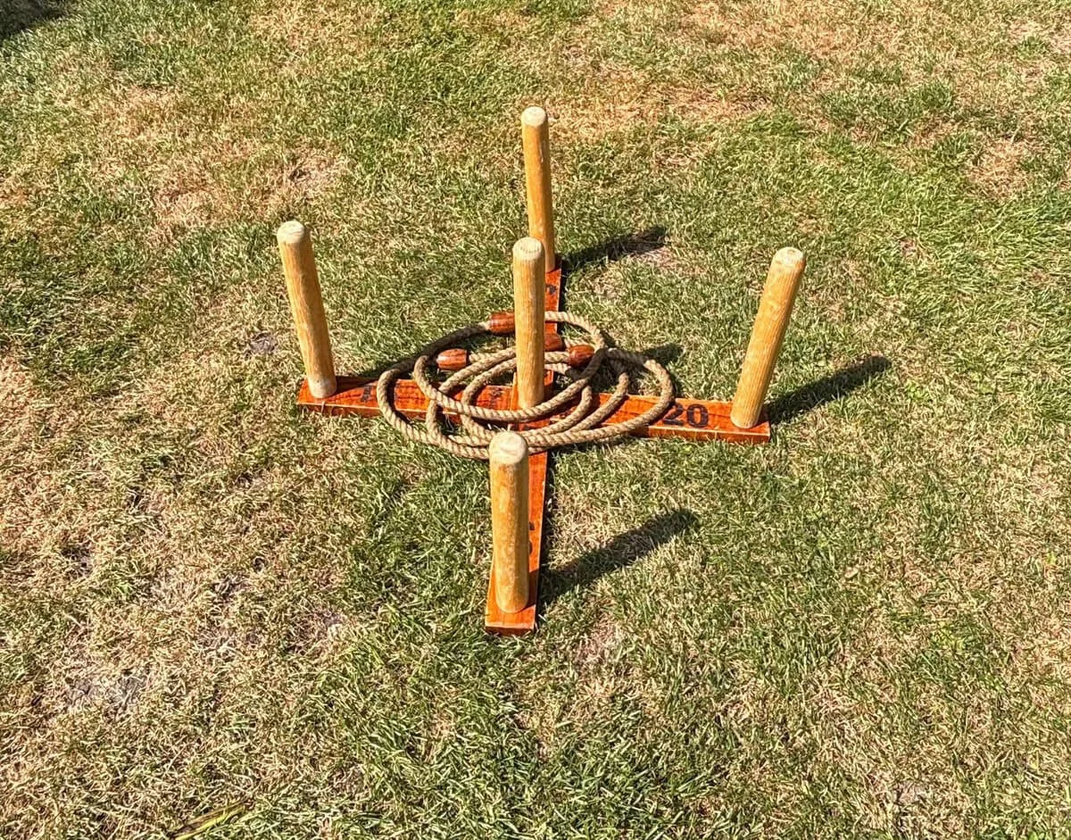Quoits wooden game with rope rings on grass, available to hire for your wedding or event.