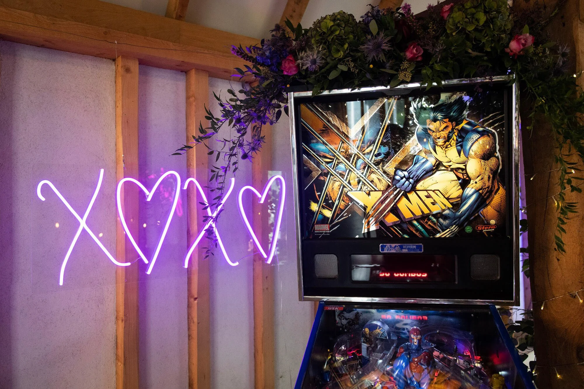 Hearts & Kisses Neon Sign in pink neon light spelling X heart X, available to hire for your wedding or event.