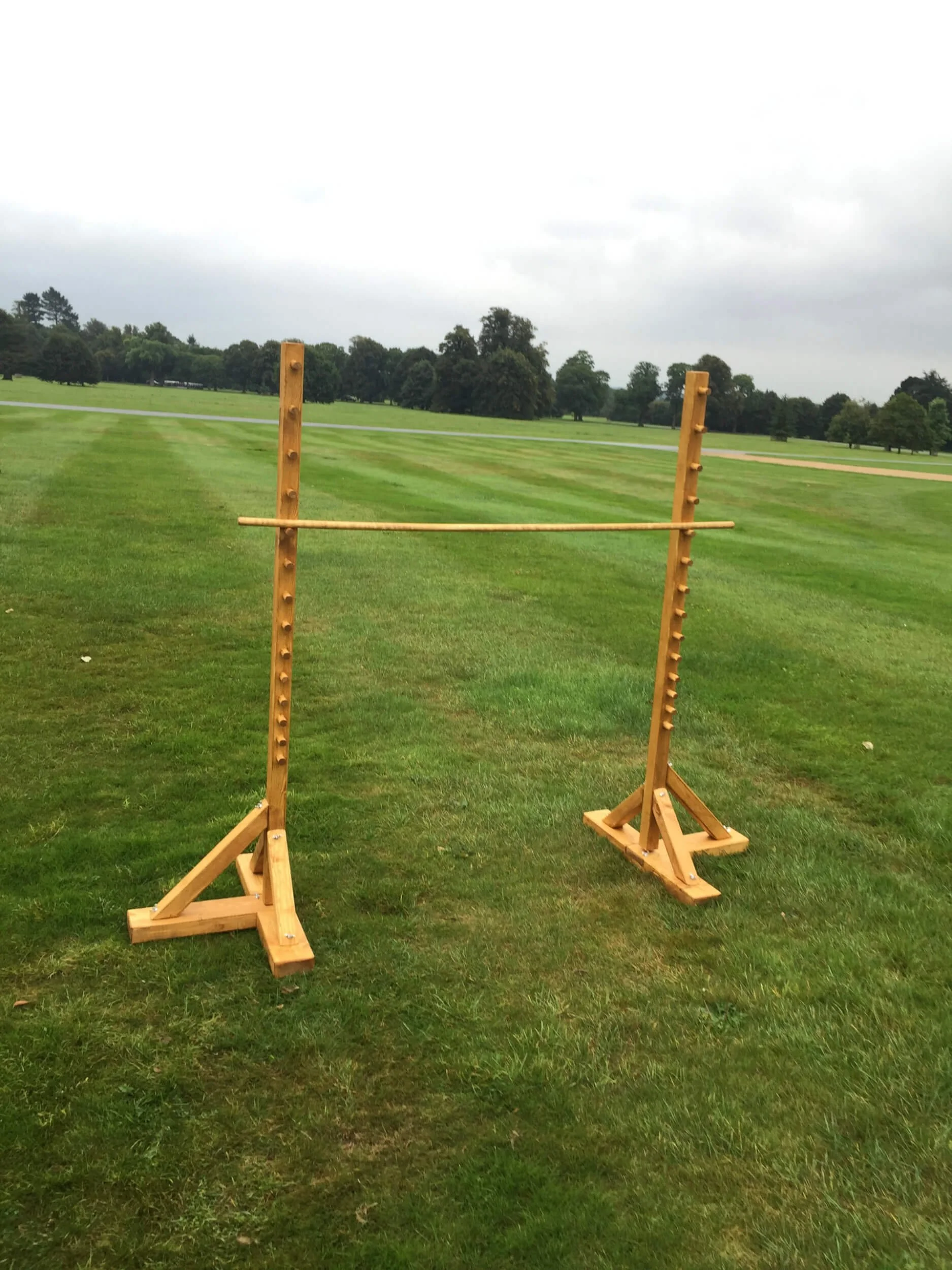 Limbo wooden game set available to hire for your wedding or event on a green lawn outdoors