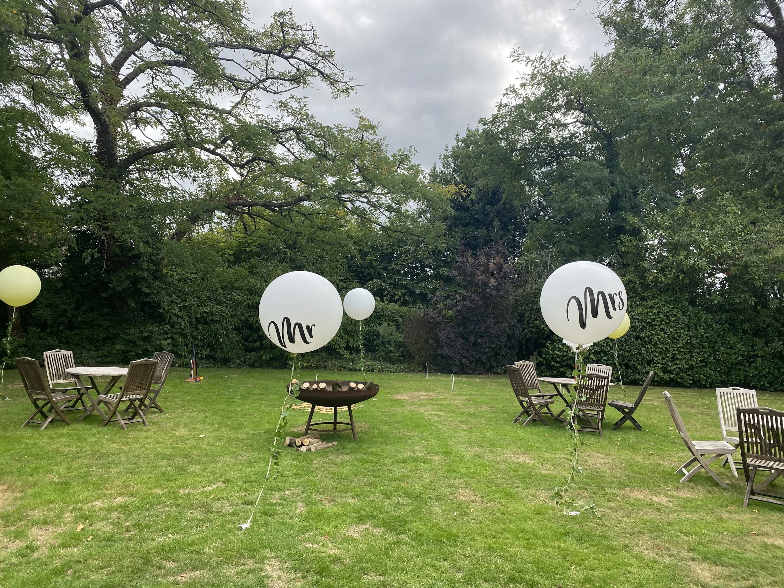 Giant Helium Balloon - Mr in white with black text, available to hire for your wedding or event in an outdoor garden setting.
