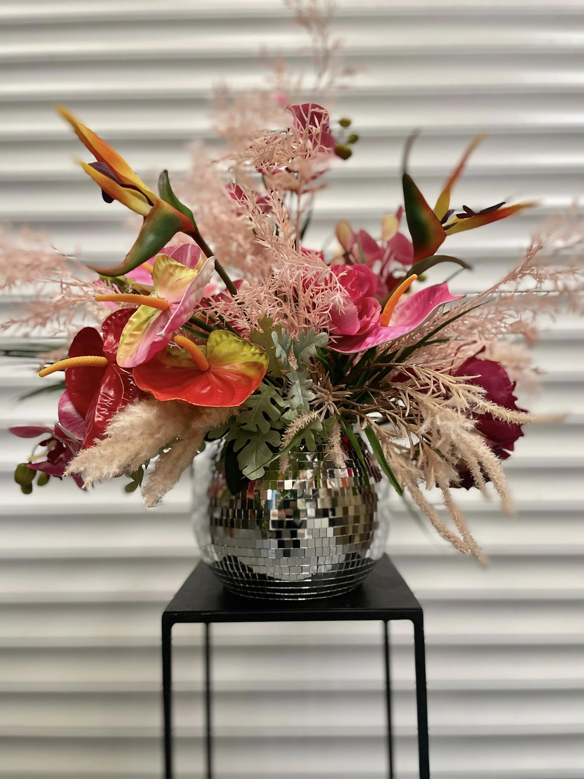 Mirror Ball Planter Silver - 8 inch filled with colourful faux flowers and foliage, available to hire for your wedding or event.