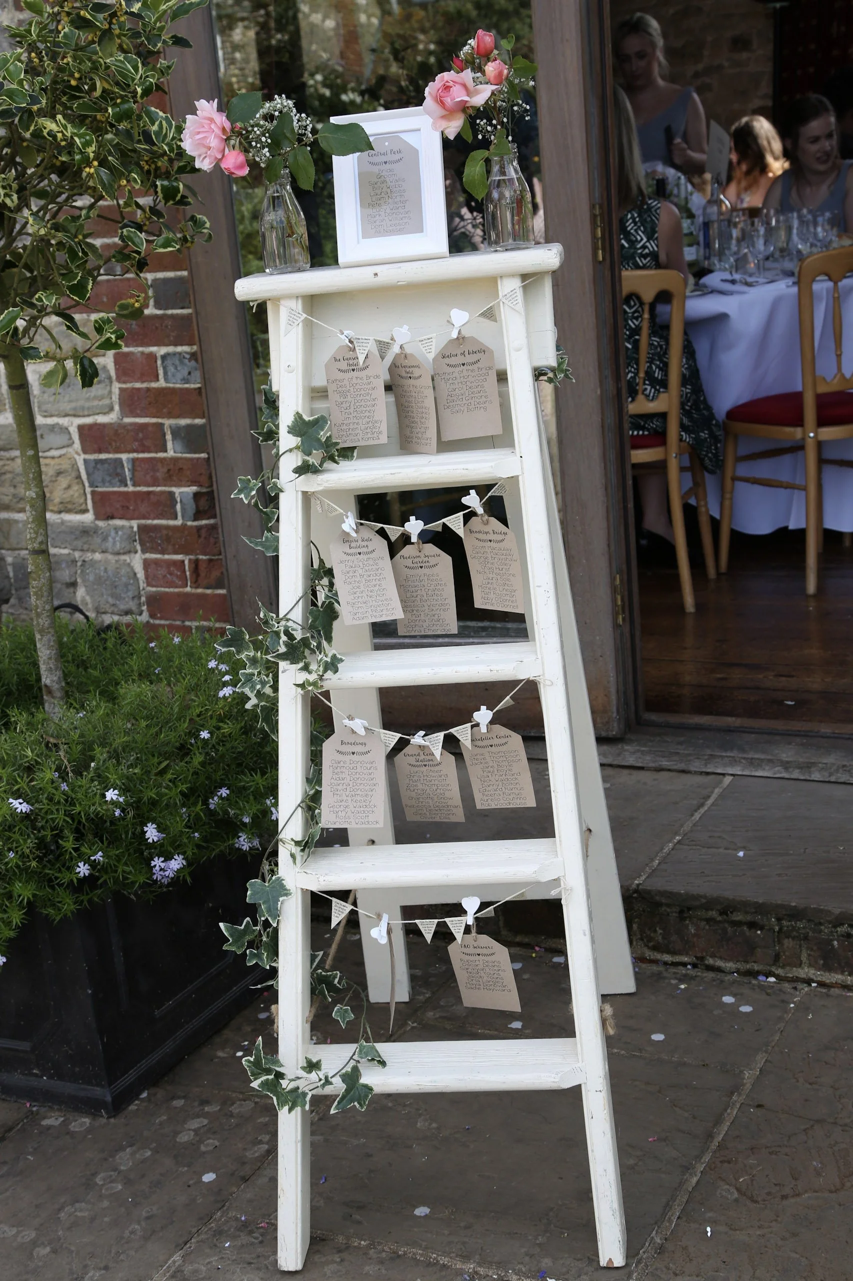 Step Ladder - Regular - Rustic White decorated with paper tags, ivy, and pink roses, available to hire for your wedding or event.
