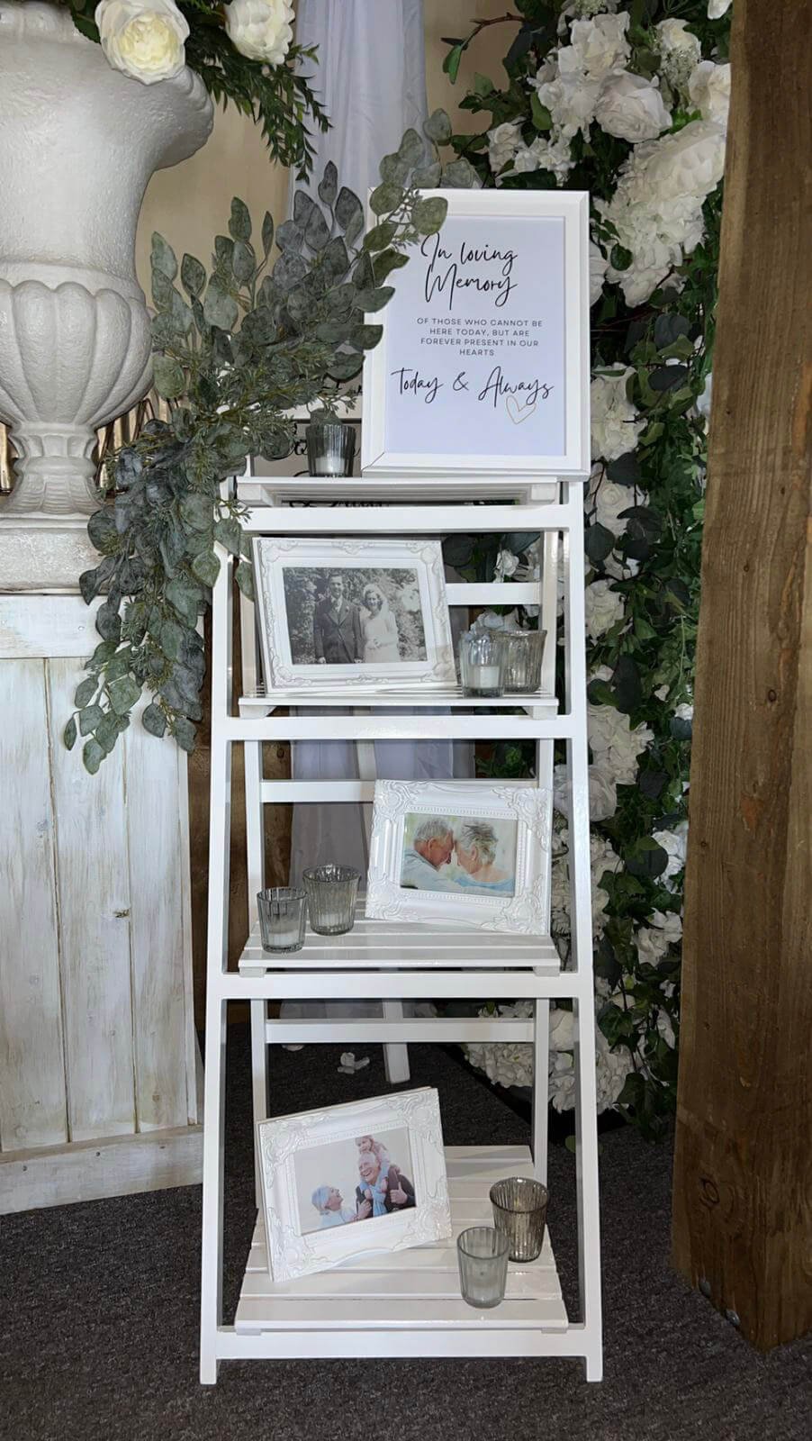 White Prop Ladder with framed photos and candles, available to hire for your wedding or event.