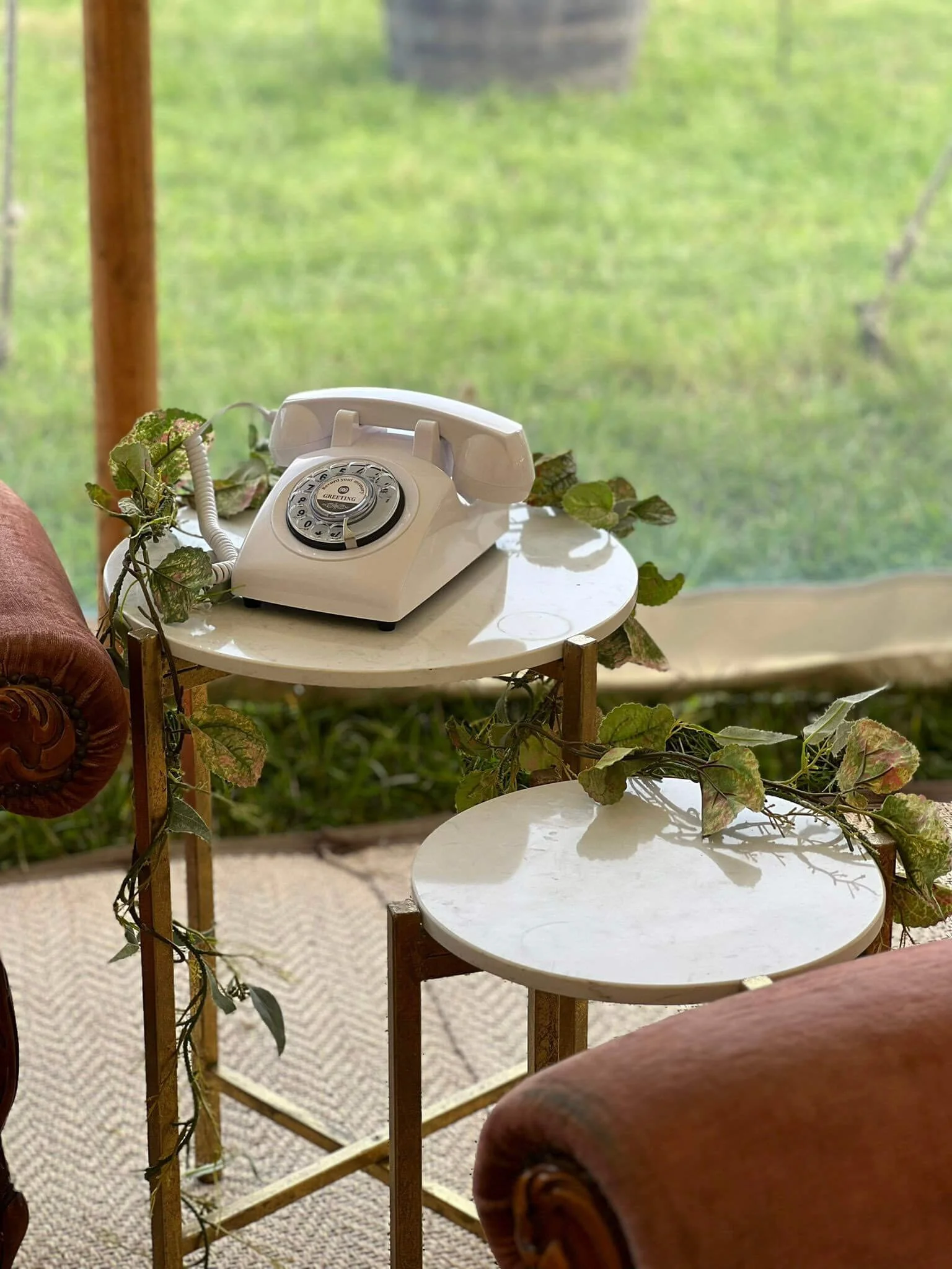 Audio Guestbook - Retro Phone in white on a small round table with faux greenery, available to hire for your wedding or event.