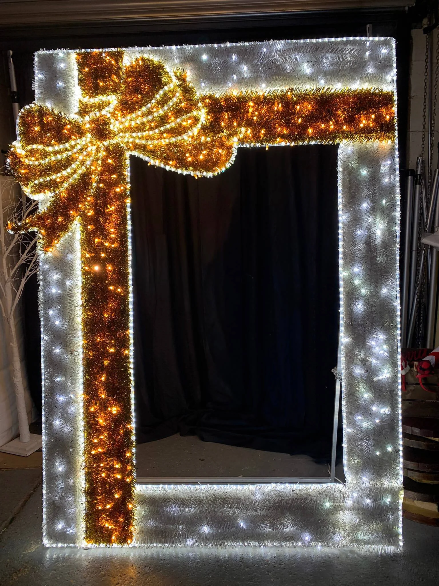 Giant Light up Photo frame - festive decorated with white and gold tinsel and warm white lights, available to hire for your wedding or event.