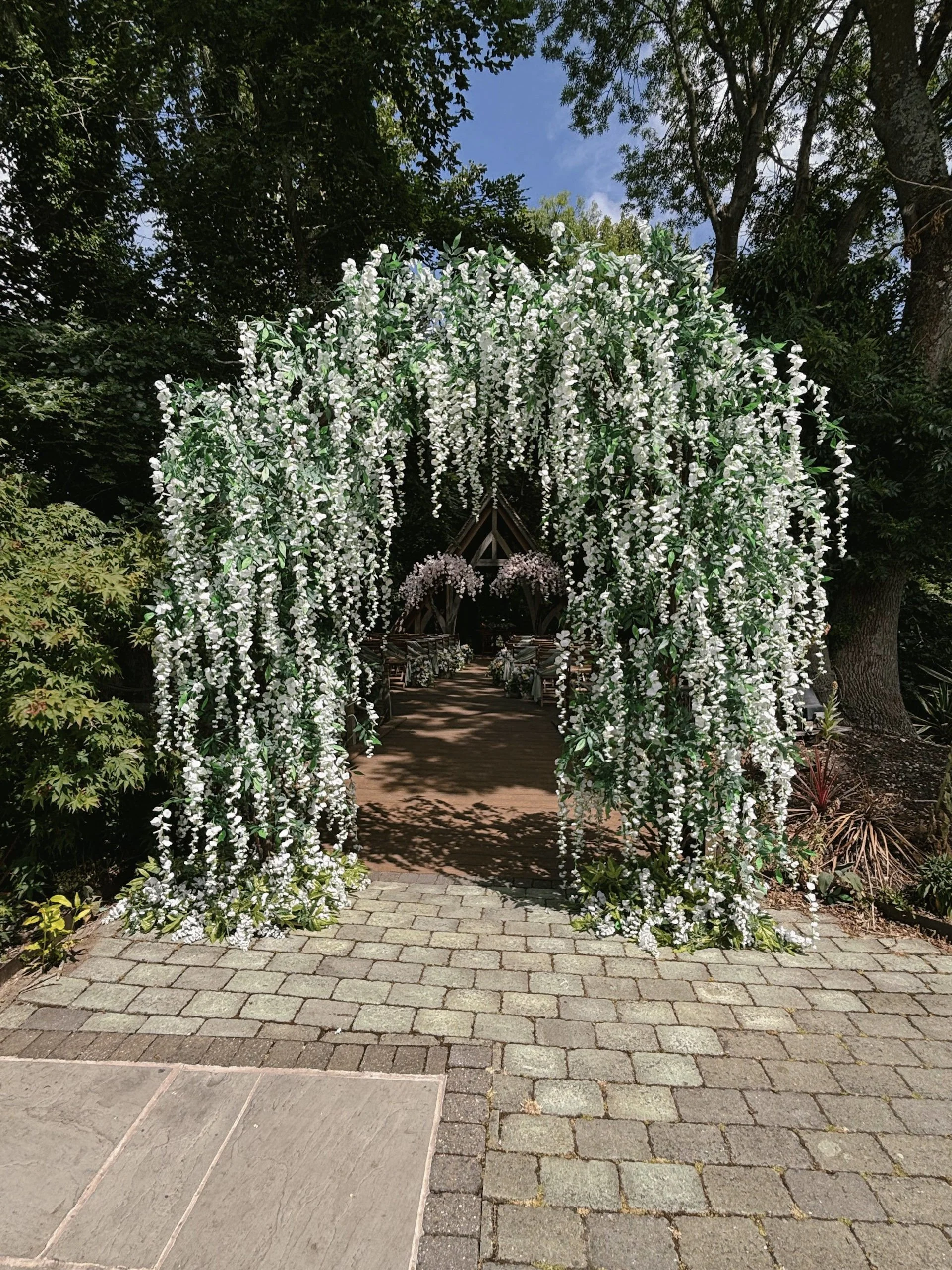 Branch Arch - Ivory Blossom 310cm x 270cm with cascading white flowers and green leaves, available to hire for your wedding or event.