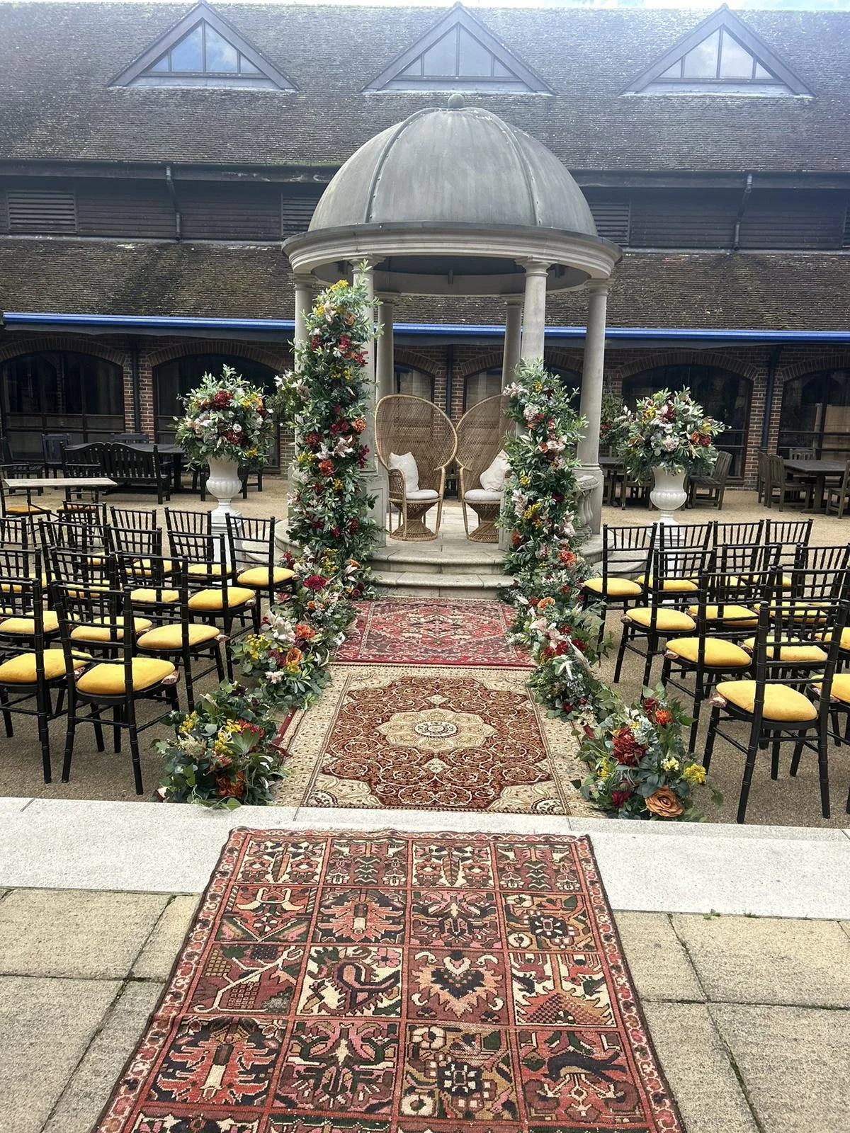 Rug - Vintage with intricate warm patterns forming an aisle, available to hire for your wedding or event in an outdoor ceremony setting.