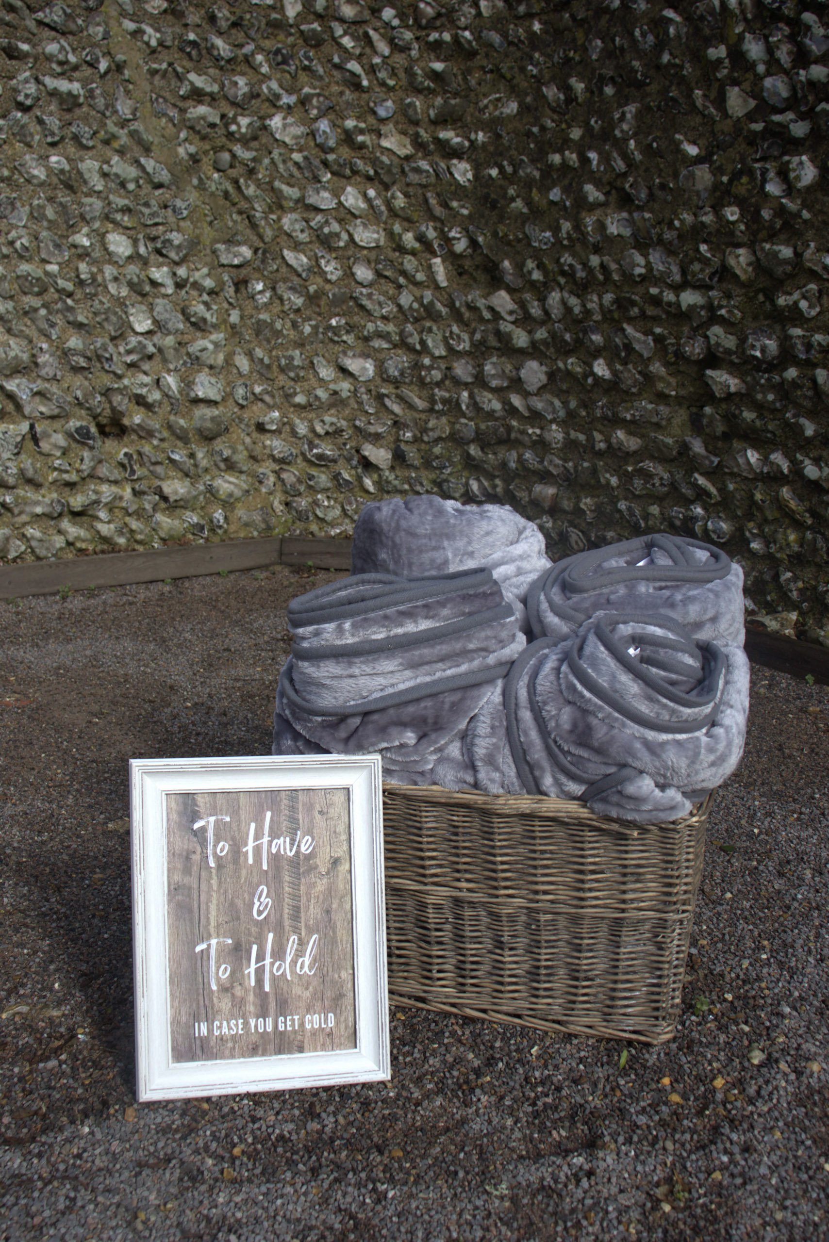 Basket of Cuddle Blankets - Luxury Faux Fur in a wicker basket, available to hire for your wedding or event to keep guests warm and cozy.
