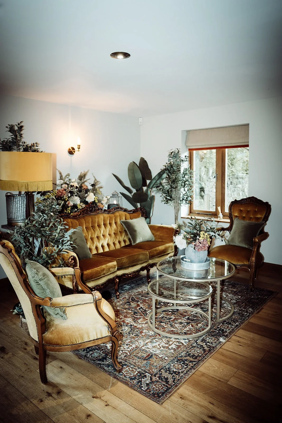 Heritage Collection - Gilded (Antique Gold) - Design Lounge Furniture Setup featuring antique gold velvet sofa and chairs around glass tables, available to hire for your wedding or event.