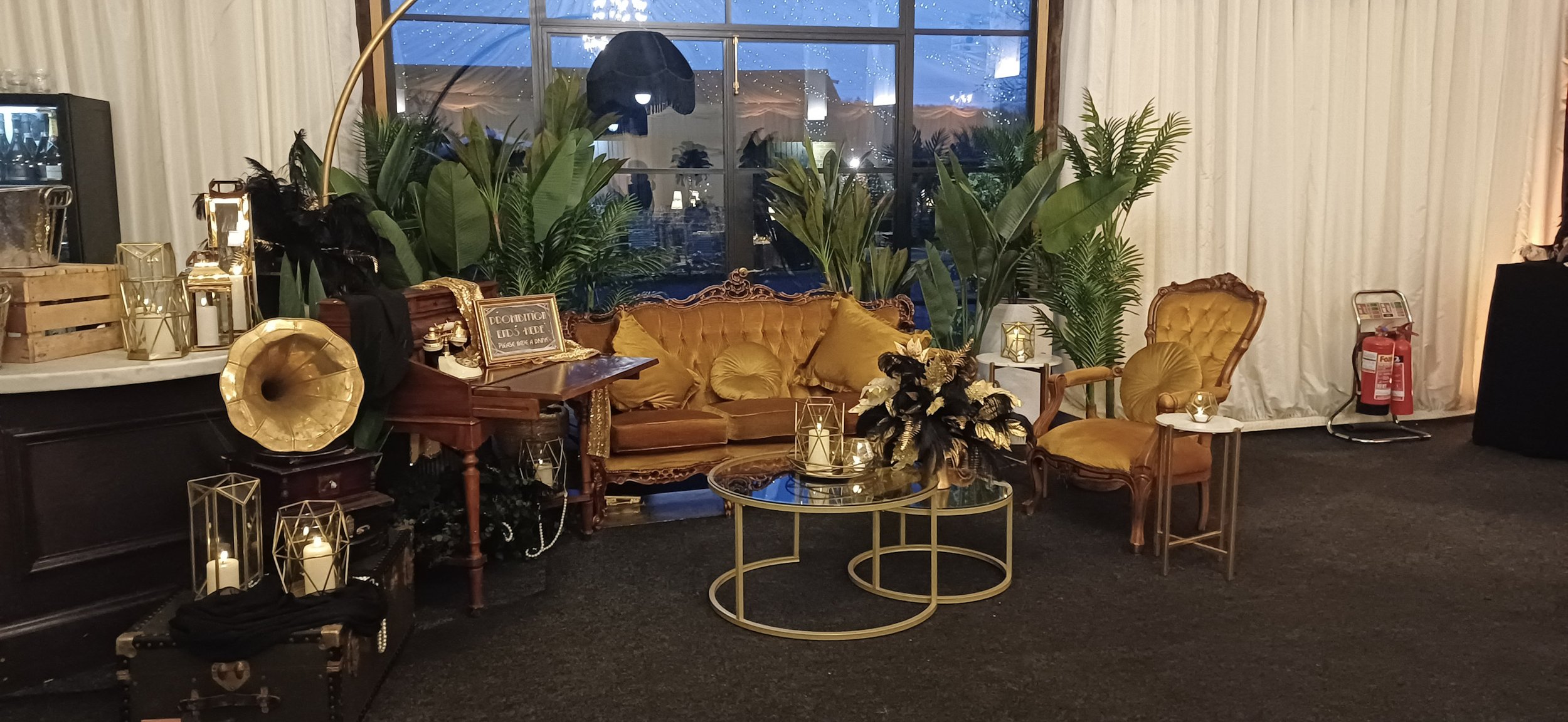 Heritage Collection - Gilded (Antique Gold) - Design Lounge Furniture Setup featuring antique gold velvet sofa and armchair with glass coffee tables, available to hire for your wedding or event.