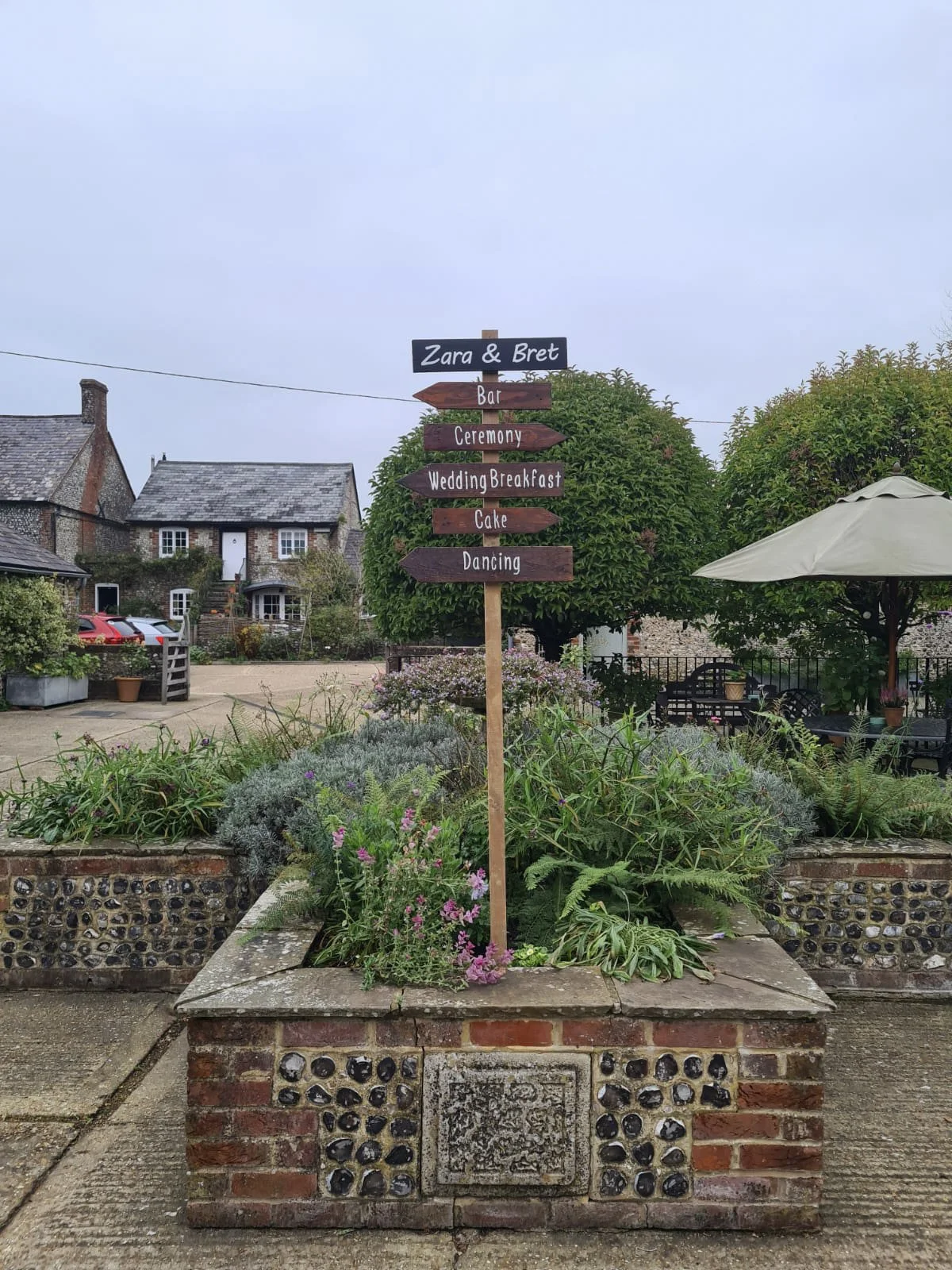 Upwaltham Festival Sign - Chalkboard with directional arrows, available to hire for your wedding or event in an outdoor garden setting.
