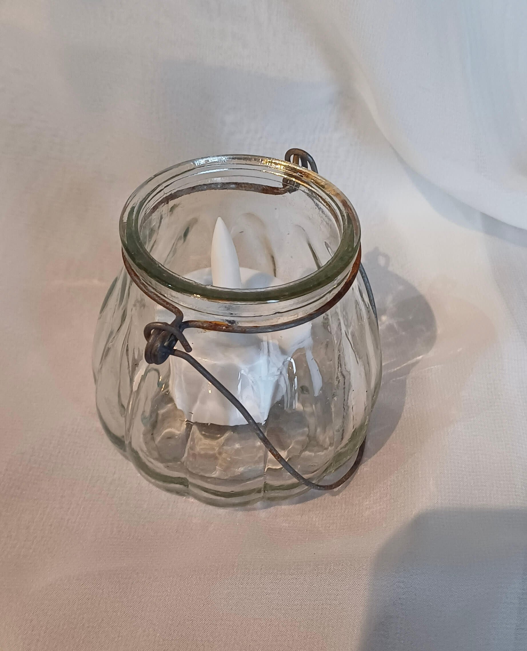 Vintage Glass Tealight Hanging Various with ribbed clear glass and metal handle, containing white LED tealight, available to hire for your wedding or event.
