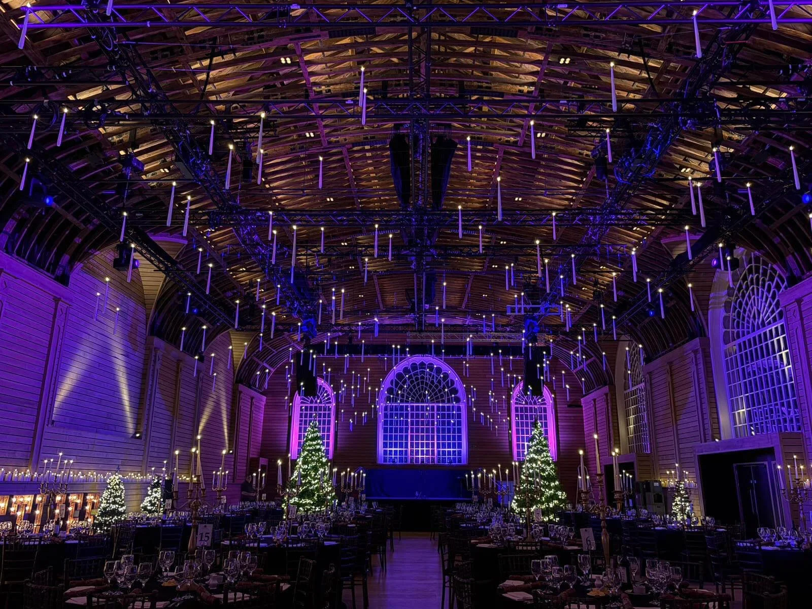 Floating Candles Prices From shown as numerous white candles hanging from the ceiling in a large hall, available to hire for your wedding or event.