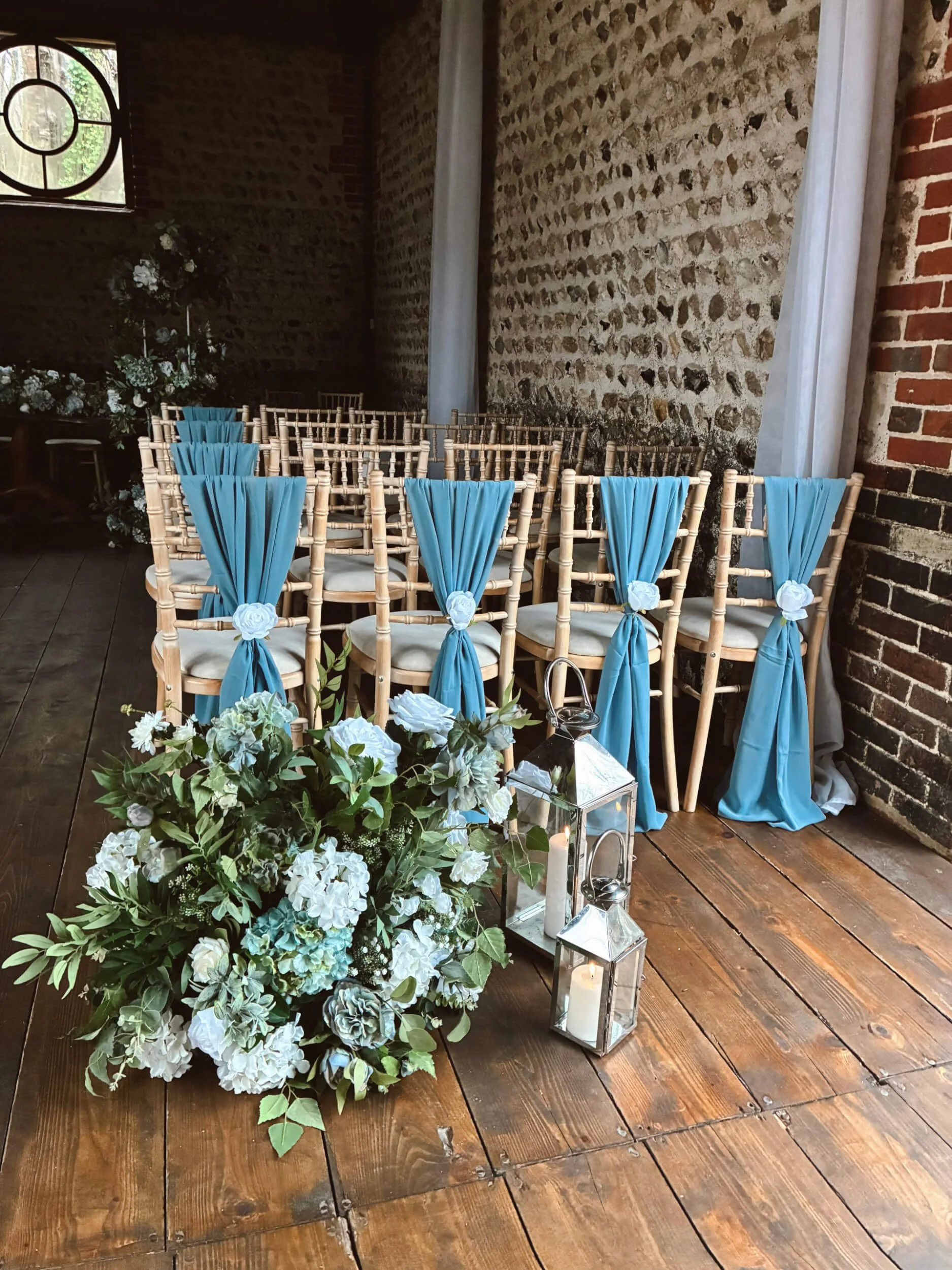 Faux Florals - Faux floral standard meadow arrangement with white and green flowers, available to hire for your wedding or event in a rustic venue setting.