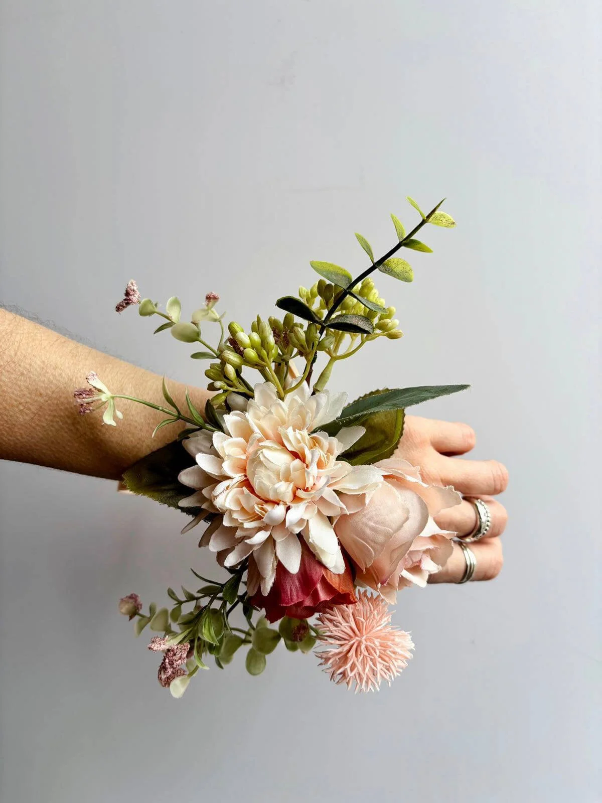 Faux Florals - Corsage for wrist or dress TO KEEP with peach and cream flowers and green leaves, available to hire for your wedding or event.